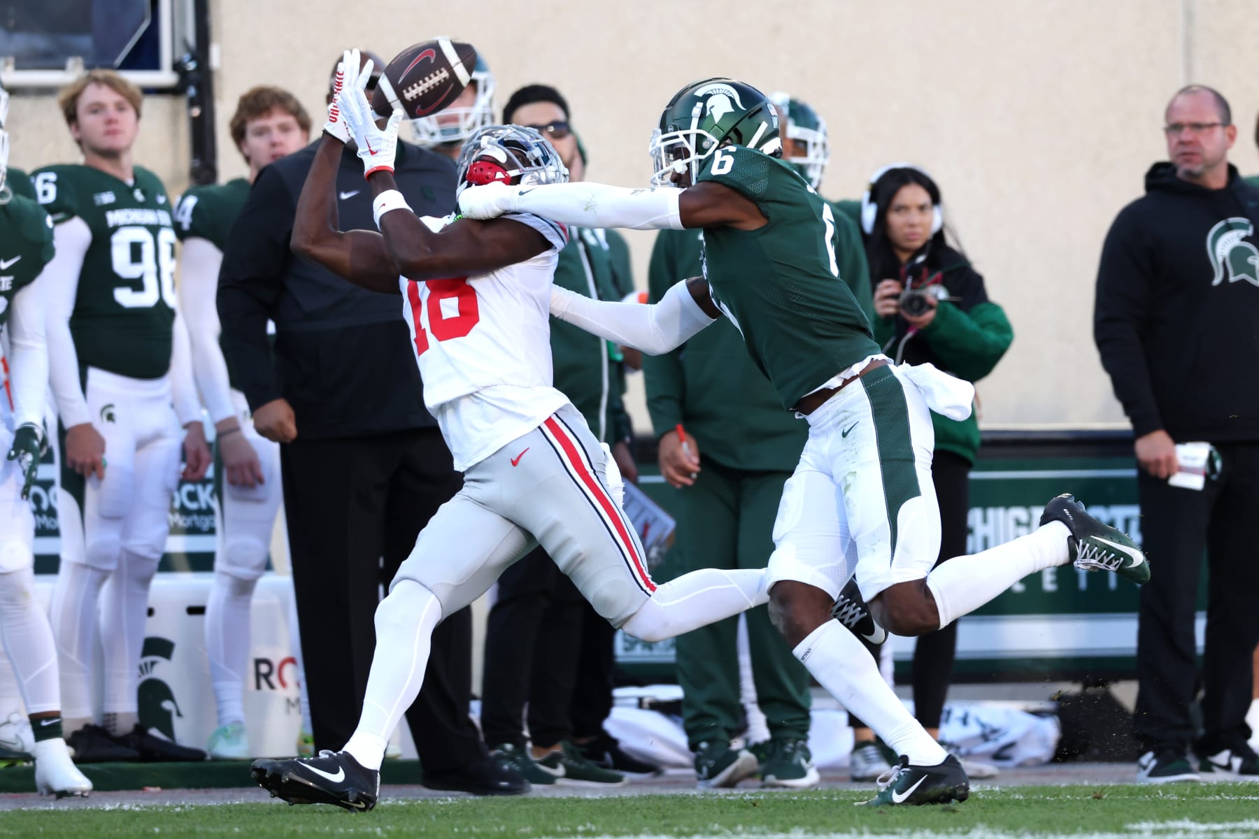 EAST LANSING, MICHIGAN - OCTOBER 08: Marvin Harrison Jr. #18 of the Ohio State Buckeyes catches a first half pass in front of Ameer Speed #6 of the Michigan State Spartans at Spartan Stadium on October 08, 2022 in East Lansing, Michigan. (Photo by Gregory Shamus/Getty Images)