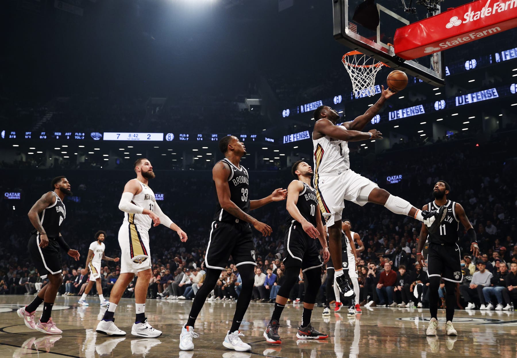 NEW YORK, NEW YORK - OCTOBER 19: Zion Williamson #1 of the New Orleans Pelicans goes to the basket as Nic Claxton #33 and Ben Simmons #10 of the Brooklyn Nets defend during the first half at Barclays Center on October 19, 2022 in the Brooklyn borough of New York City. NOTE TO USER: User expressly acknowledges and agrees that, by downloading and or using this photograph, User is consenting to the terms and conditions of the Getty Images License Agreement. (Photo by Sarah Stier/Getty Images)