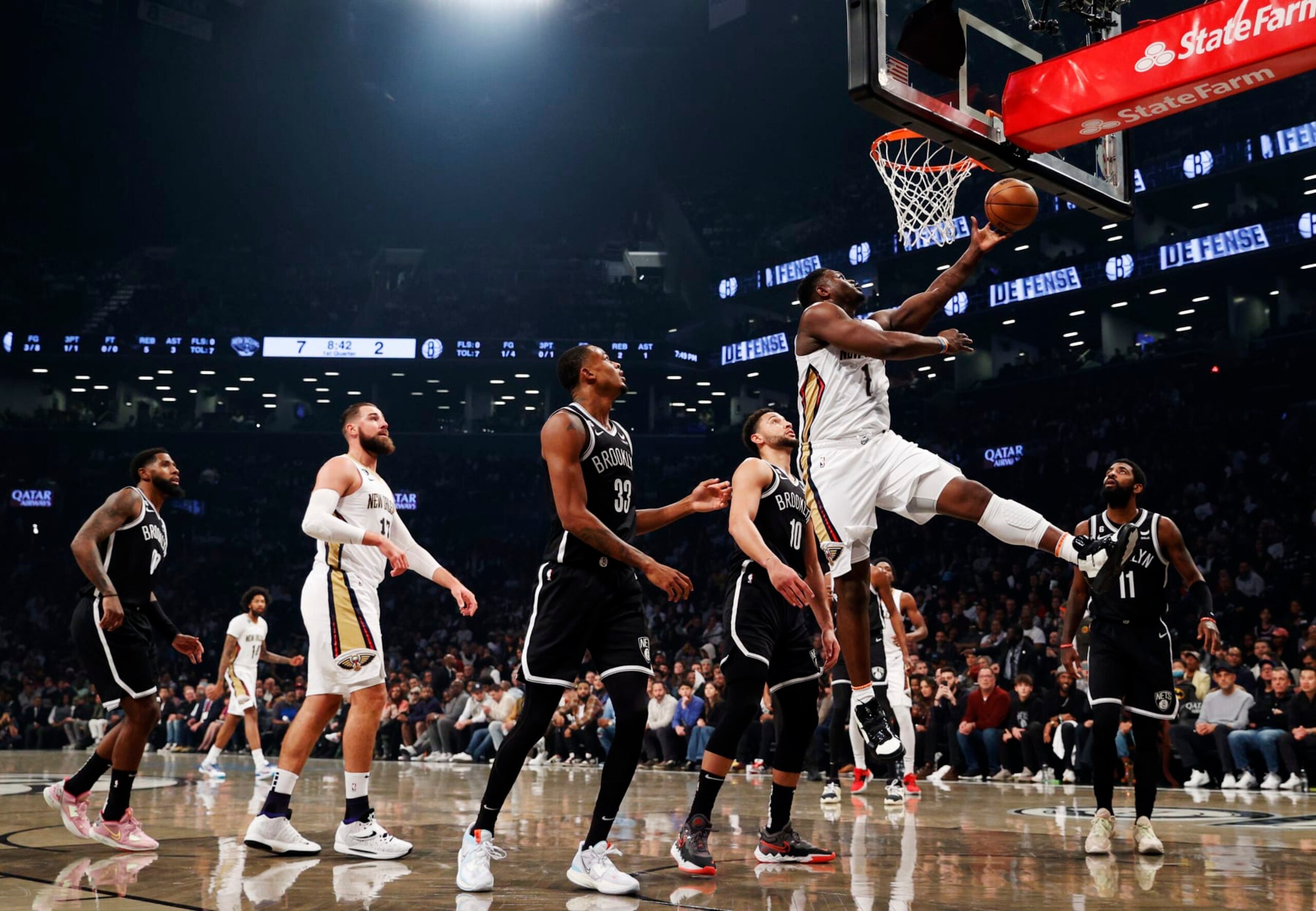 NEW YORK, NEW YORK - OCTOBER 19: Zion Williamson #1 of the New Orleans Pelicans goes to the basket as Nic Claxton #33 and Ben Simmons #10 of the Brooklyn Nets defend during the first half at Barclays Center on October 19, 2022 in the Brooklyn borough of New York City. NOTE TO USER: User expressly acknowledges and agrees that, by downloading and or using this photograph, User is consenting to the terms and conditions of the Getty Images License Agreement. (Photo by Sarah Stier/Getty Images)