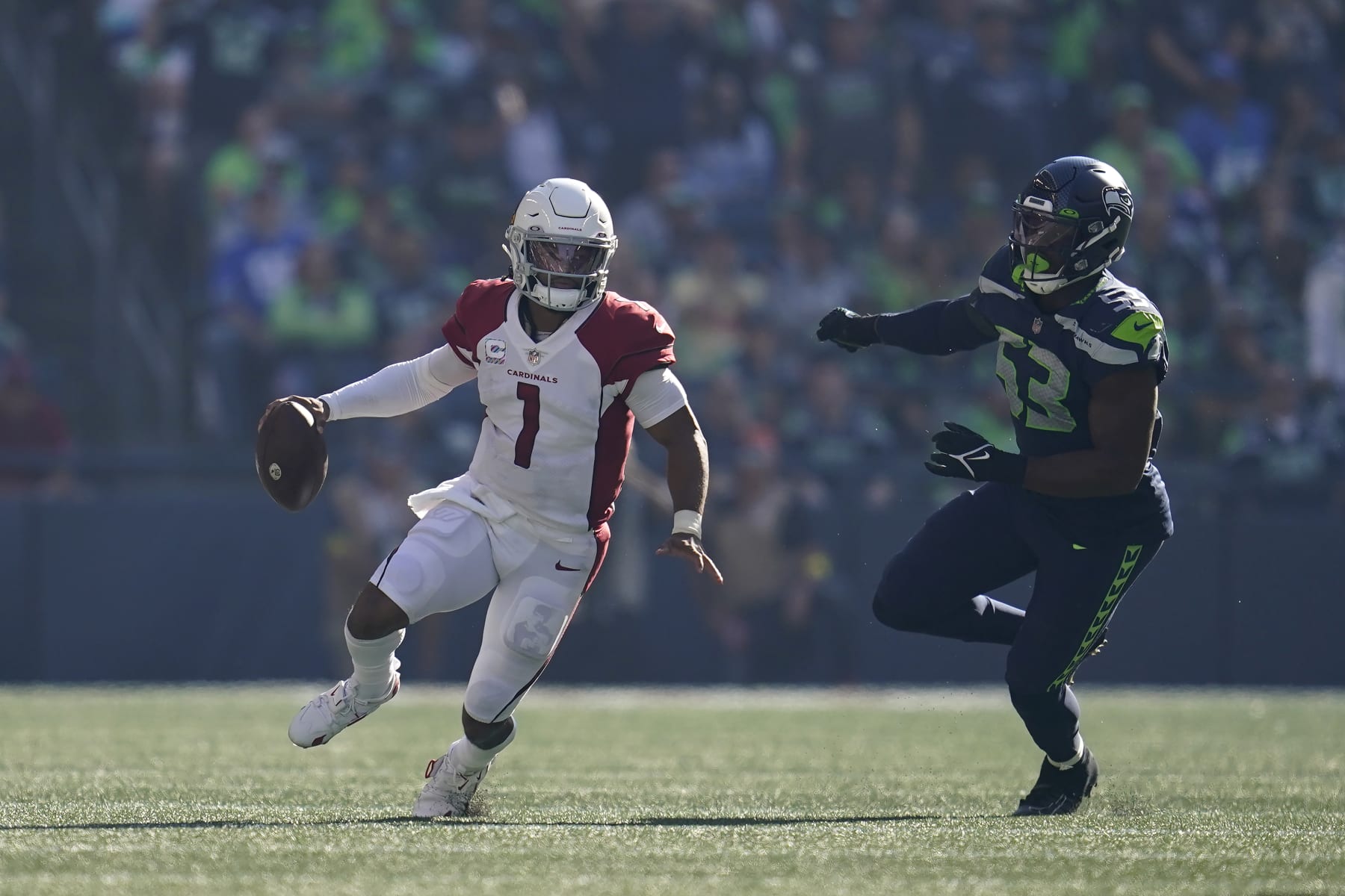 Arizona Cardinals quarterback Kyler Murray (1) scrambles away from Seattle Seahawks linebacker Boye Mafe (53) during the second half of an NFL football game in Seattle, Sunday, Oct. 16, 2022. (AP Photo/Abbie Parr)