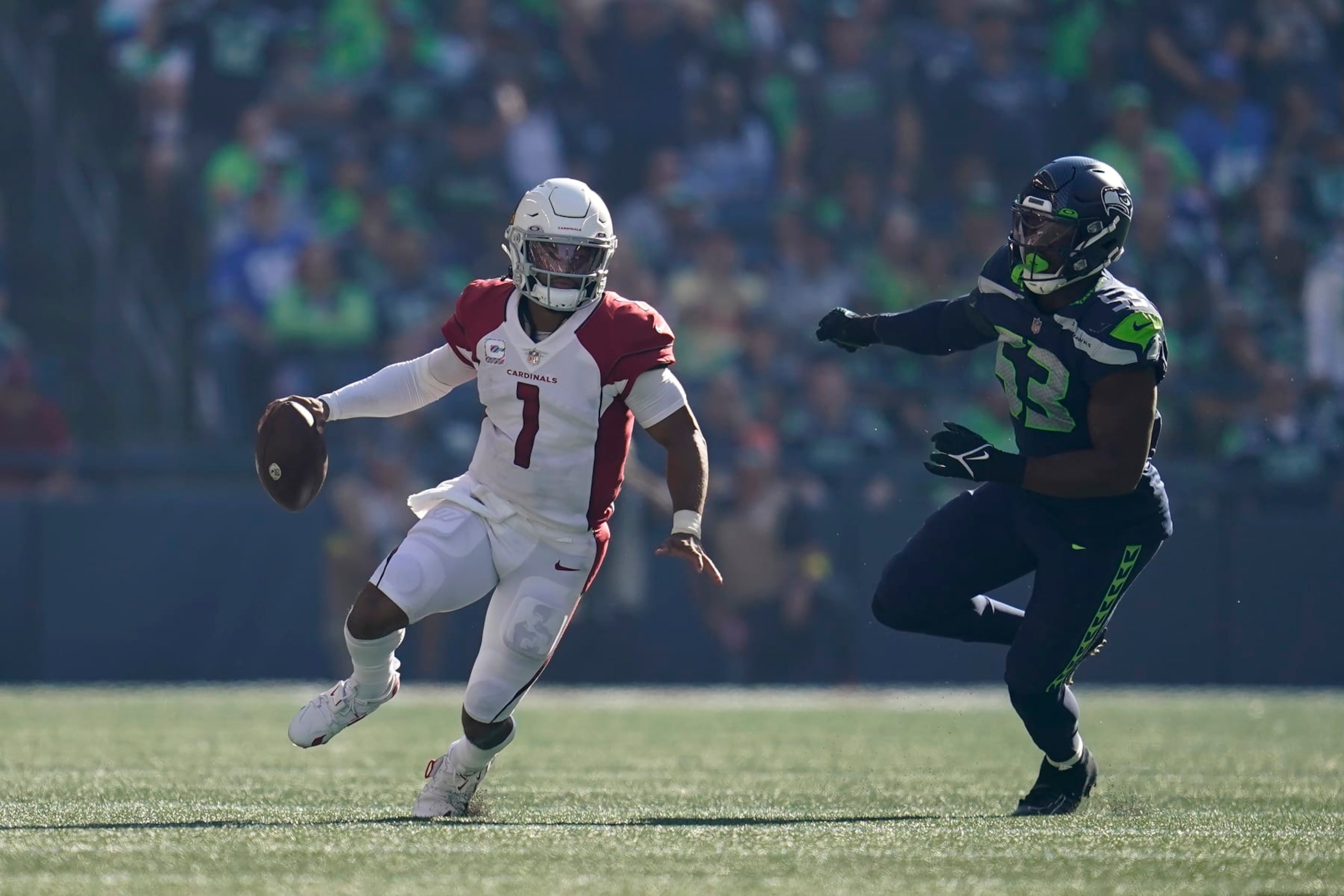 Arizona Cardinals quarterback Kyler Murray (1) scrambles away from Seattle Seahawks linebacker Boye Mafe (53) during the second half of an NFL football game in Seattle, Sunday, Oct. 16, 2022. (AP Photo/Abbie Parr)