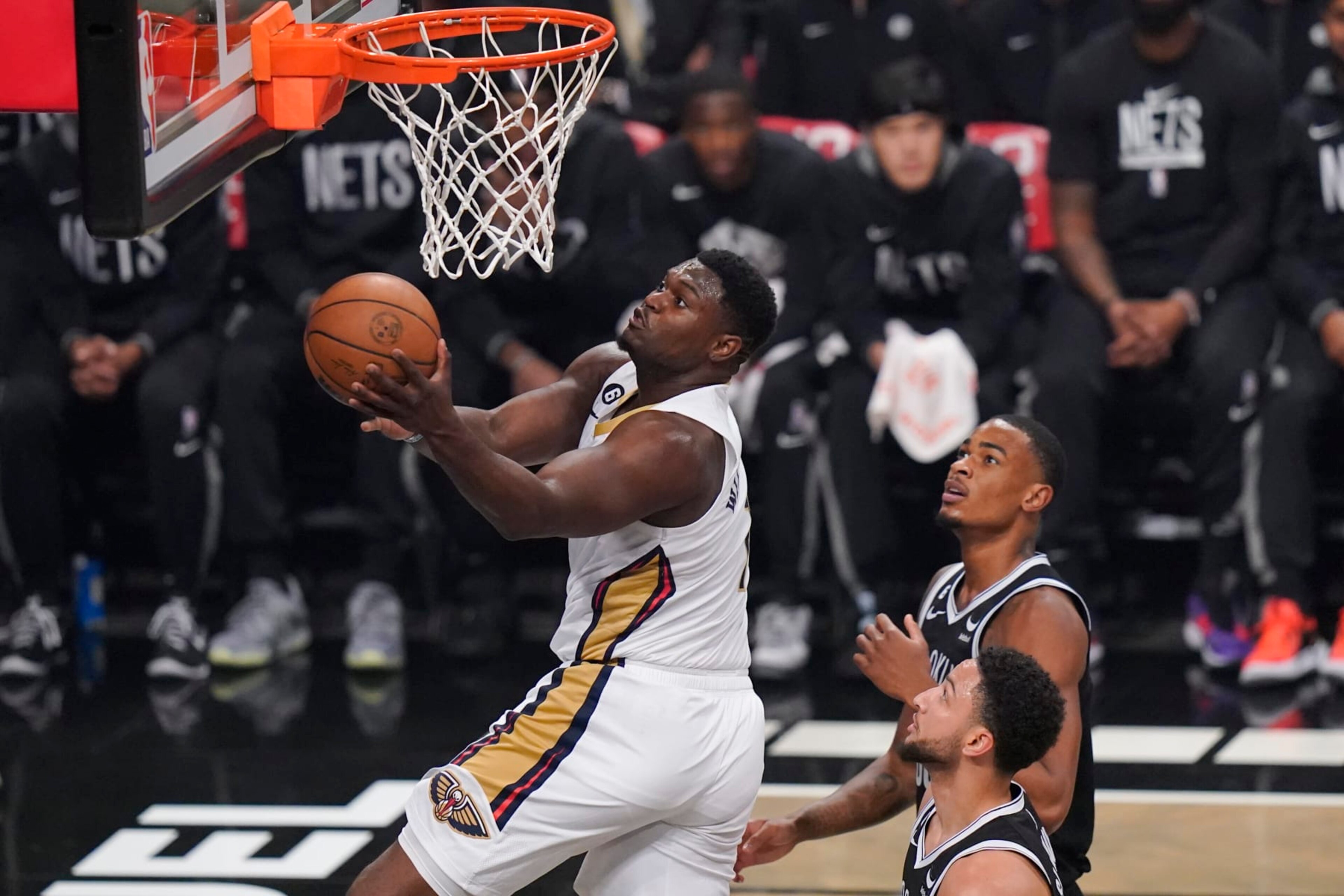 New Orleans Pelicans' Zion Williamson, left, drives past Brooklyn Nets' Nic Claxton, top right, and Ben Simmons during the first half of an NBA basketball game Wednesday, Oct. 19, 2022 in New York. (AP Photo/Frank Franklin II) New Orleans Pelicans' Zion Williamson, left, drives past Brooklyn Nets' Nic Claxton, top right, and Ben Simmons during the first half of an NBA basketball game Wednesday, Oct. 19, 2022 in New York. (AP Photo/Frank Franklin II)