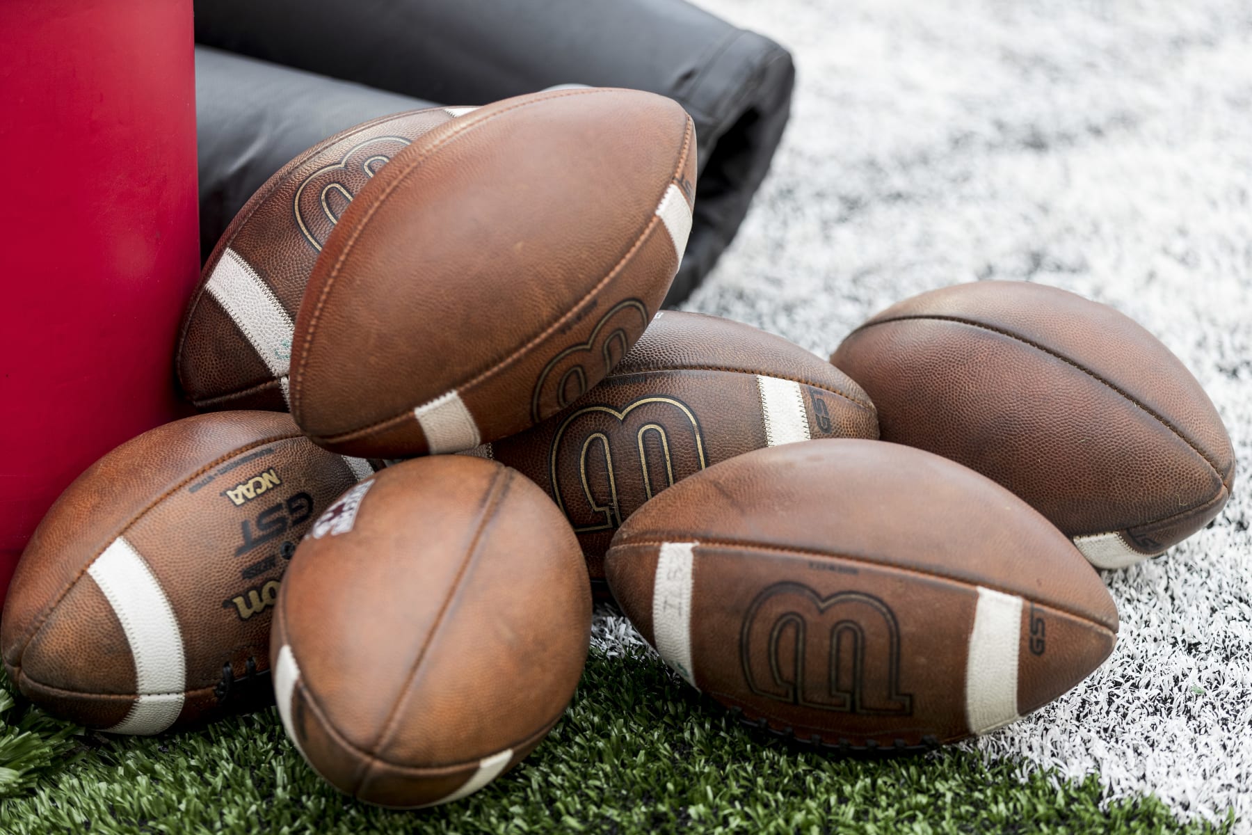 MADISON, WI - SEPTEMBER 17: A bunch of Wilson footballs site on the field durning warm ups prior to a college football game between the New Mexico State Aggies and the Wisconsin Badgers on September 17th, 2022 at Barry Alvarez field in Camp Randall Stadium in Madison, WI. (Photo by Dan Sanger/Icon Sportswire via Getty Images)