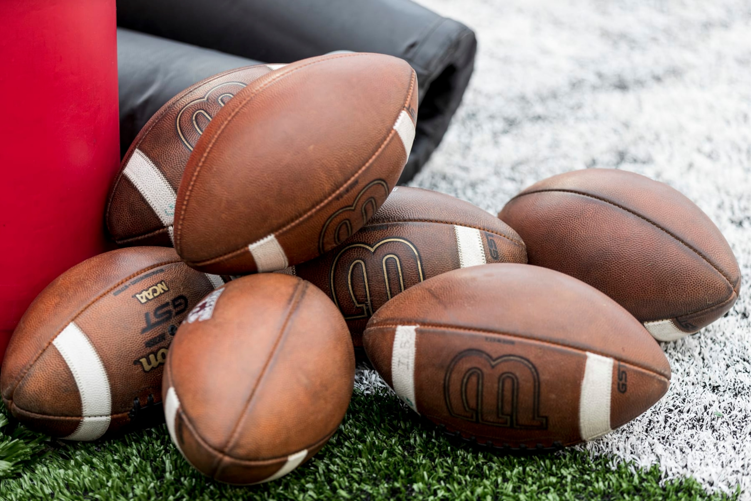 MADISON, WI - SEPTEMBER 17: A bunch of Wilson footballs site on the field durning warm ups prior to a college football game between the New Mexico State Aggies and the Wisconsin Badgers on September 17th, 2022 at Barry Alvarez field in Camp Randall Stadium in Madison, WI. (Photo by Dan Sanger/Icon Sportswire via Getty Images)