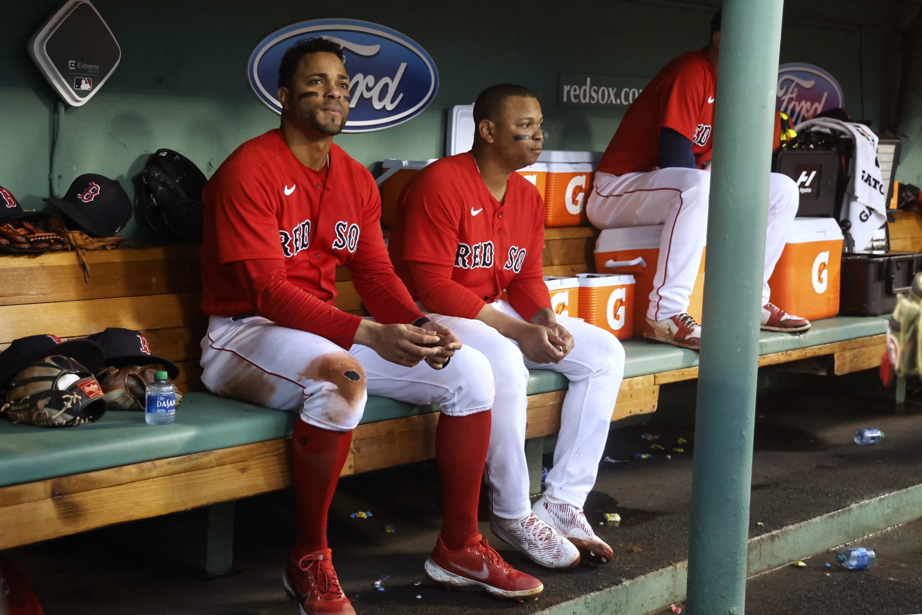 BOSTON, MA - OCTOBER 5: Rafael Devers #11 of the Boston Red Sox and Xander Bogaerts, left, in the dugout during the fourth inning of the game against the Tampa Bay Rays at Fenway Park on October 5, 2022 in Boston, Massachusetts. (Photo By Winslow Townson/Getty Images)