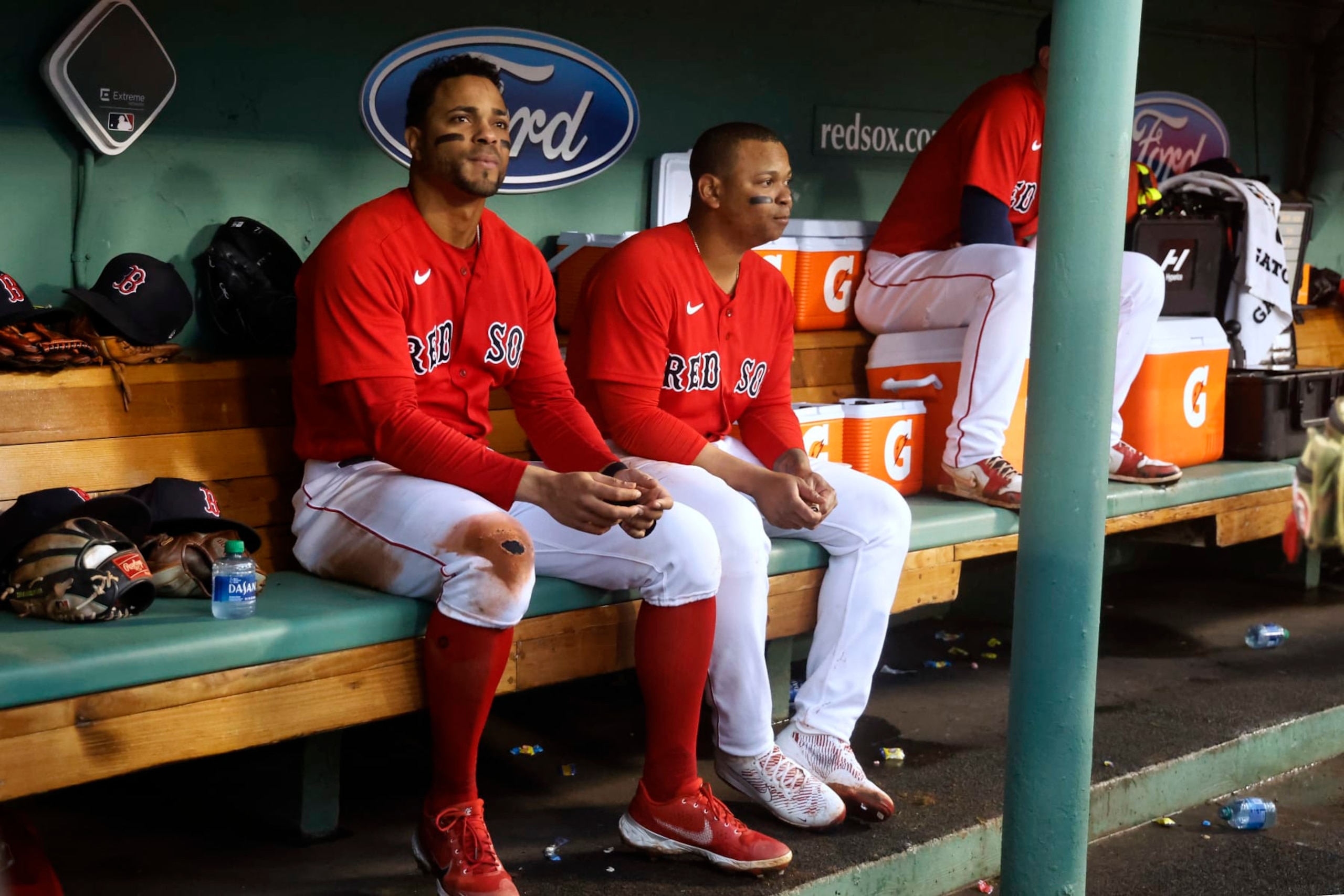 BOSTON, MA - OCTOBER 5: Rafael Devers #11 of the Boston Red Sox and Xander Bogaerts, left, in the dugout during the fourth inning of the game against the Tampa Bay Rays at Fenway Park on October 5, 2022 in Boston, Massachusetts. (Photo By Winslow Townson/Getty Images)