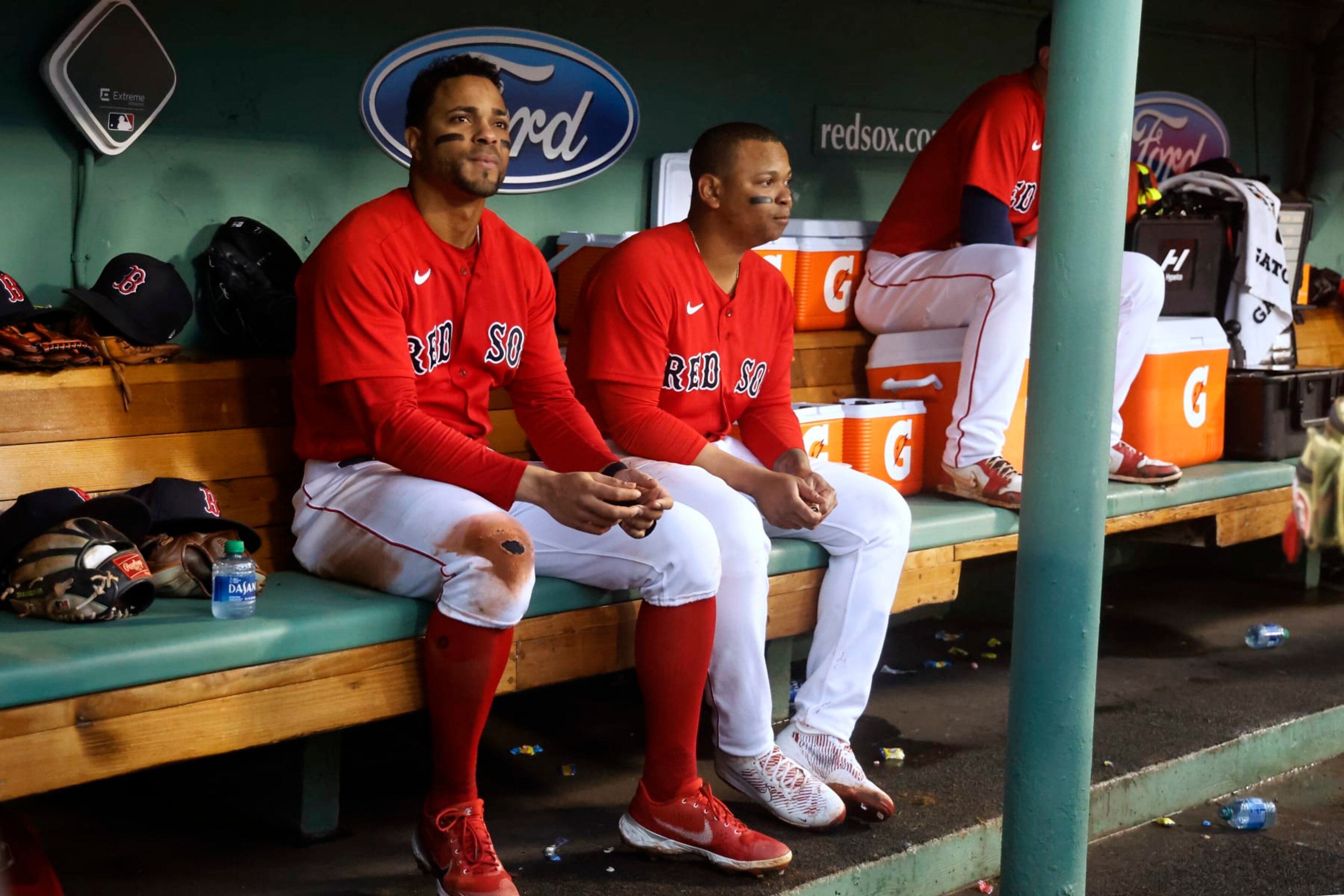 BOSTON, MA - OCTOBER 5: Rafael Devers #11 of the Boston Red Sox and Xander Bogaerts, left, in the dugout during the fourth inning of the game against the Tampa Bay Rays at Fenway Park on October 5, 2022 in Boston, Massachusetts. (Photo By Winslow Townson/Getty Images)