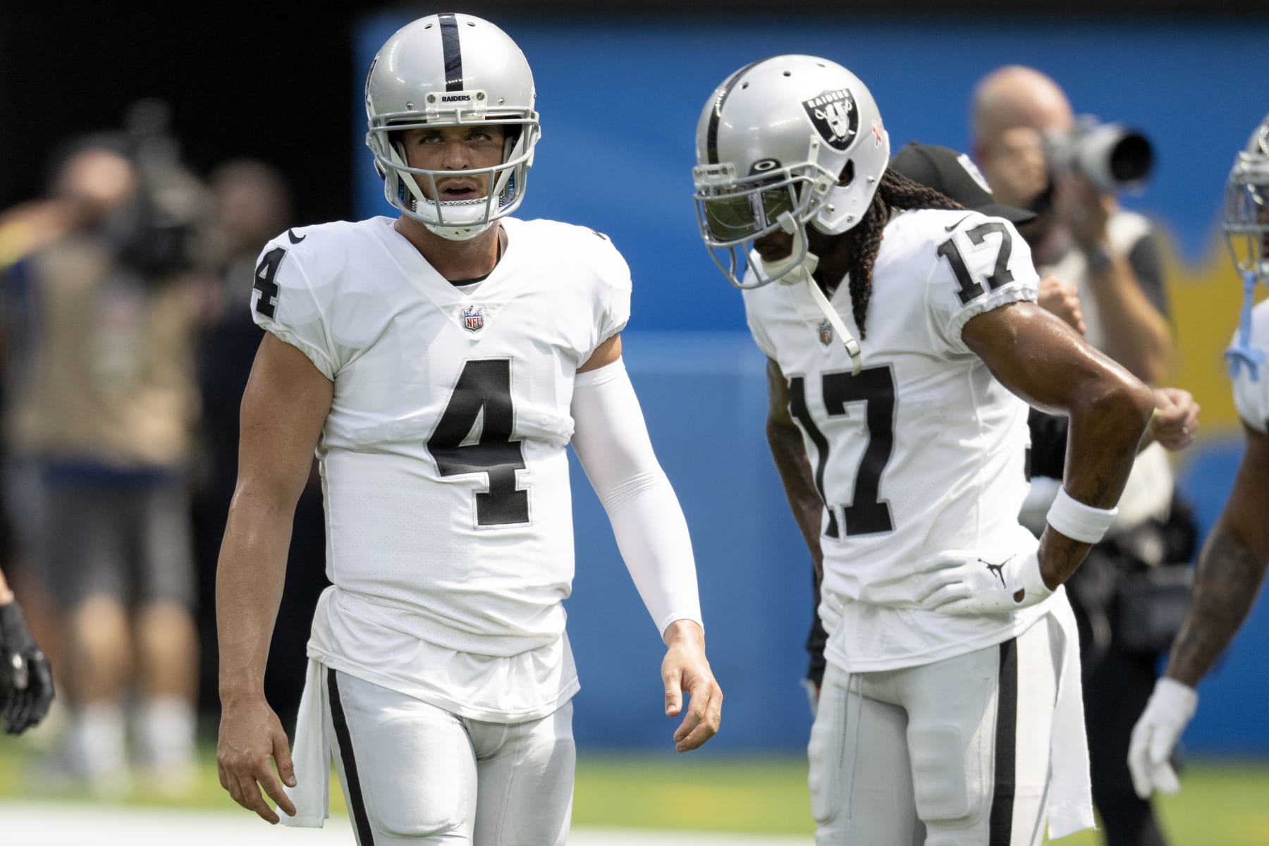 Las Vegas Raiders quarterback Derek Carr (4) walks past Davante Adams (17) while warming up to play the Los Angeles Chargers. during an NFL Football Game Sunday, Sept. 11, 2022, in Inglewood, Calif. (AP Photo/John McCoy)