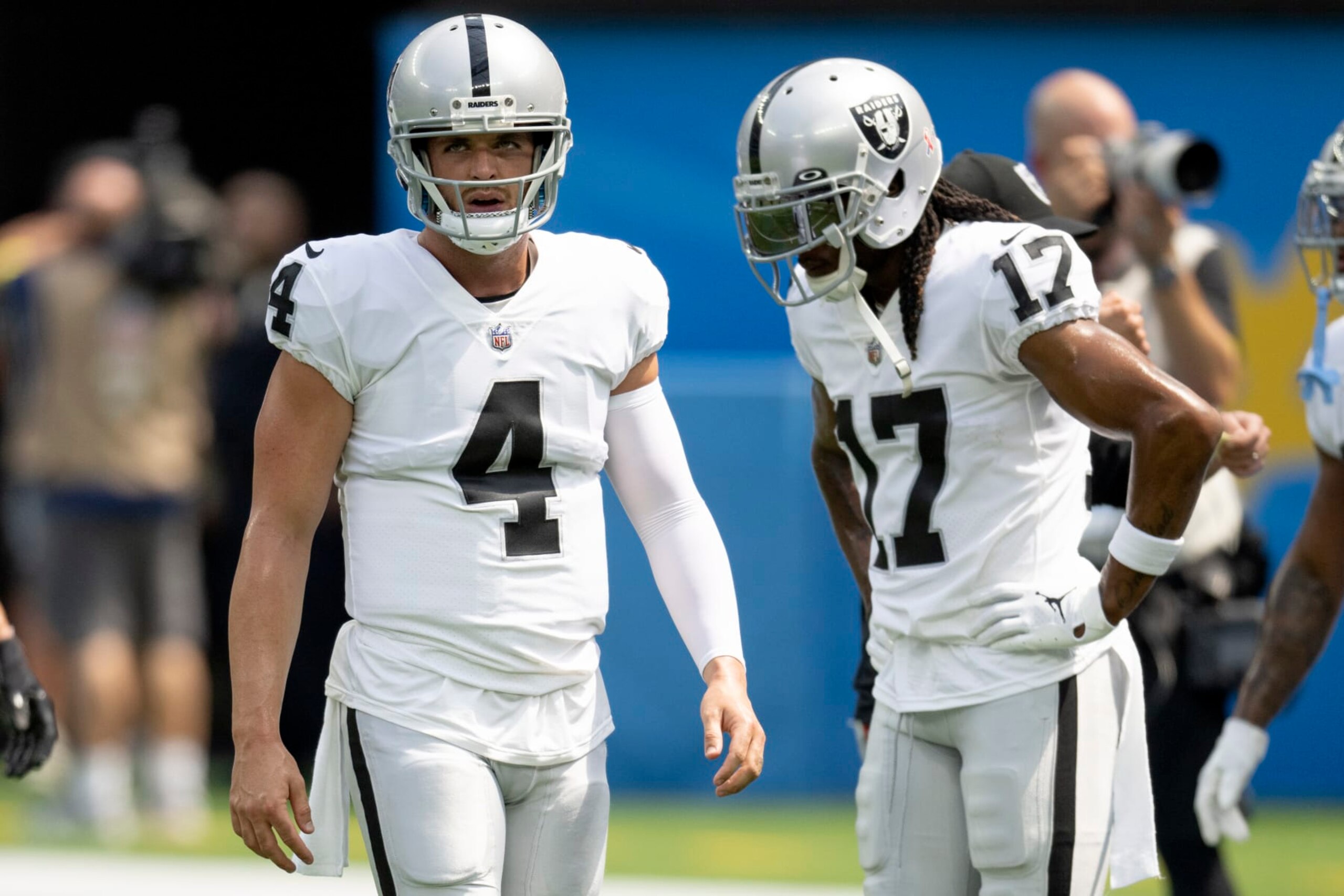 Las Vegas Raiders quarterback Derek Carr (4) walks past Davante Adams (17) while warming up to play the Los Angeles Chargers. during an NFL Football Game Sunday, Sept. 11, 2022, in Inglewood, Calif. (AP Photo/John McCoy)