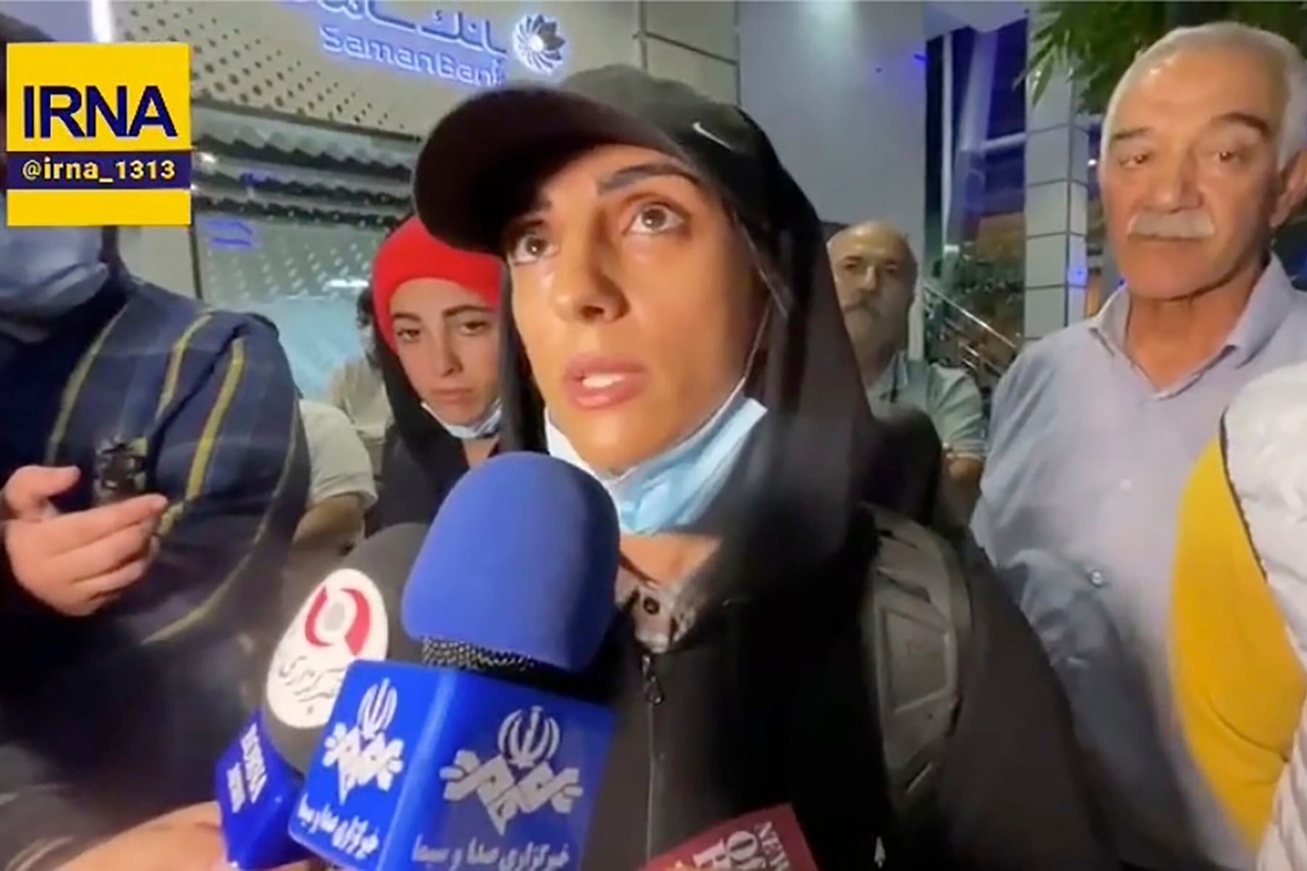 In this image taken from video by Iran's state-run IRNA news agency, Iranian competitive climber Elnaz Rekabi speaks to journalists in Imam Khomeini International Airport in Tehran, Iran, Wednesday, Oct. 19, 2022. Rekabi received a hero's welcome on her return to Tehran early Wednesday, after competing in South Korea without wearing a mandatory headscarf required of female athletes from the Islamic Republic. Rekabi has described her not wearing a hijab as "unintentional" after Farsi-language media abroad raised concerns about her safety. (IRNA via AP) In this image taken from video by Iran's state-run IRNA news agency, Iranian competitive climber Elnaz Rekabi speaks to journalists in Imam Khomeini International Airport in Tehran, Iran, Wednesday, Oct. 19, 2022. Rekabi received a hero's welcome on her return to Tehran early Wednesday, after competing in South Korea without wearing a mandatory headscarf required of female athletes from the Islamic Republic. Rekabi has described her not wearing a hijab as "unintentional" after Farsi-language media abroad raised concerns about her safety. (IRNA via AP)