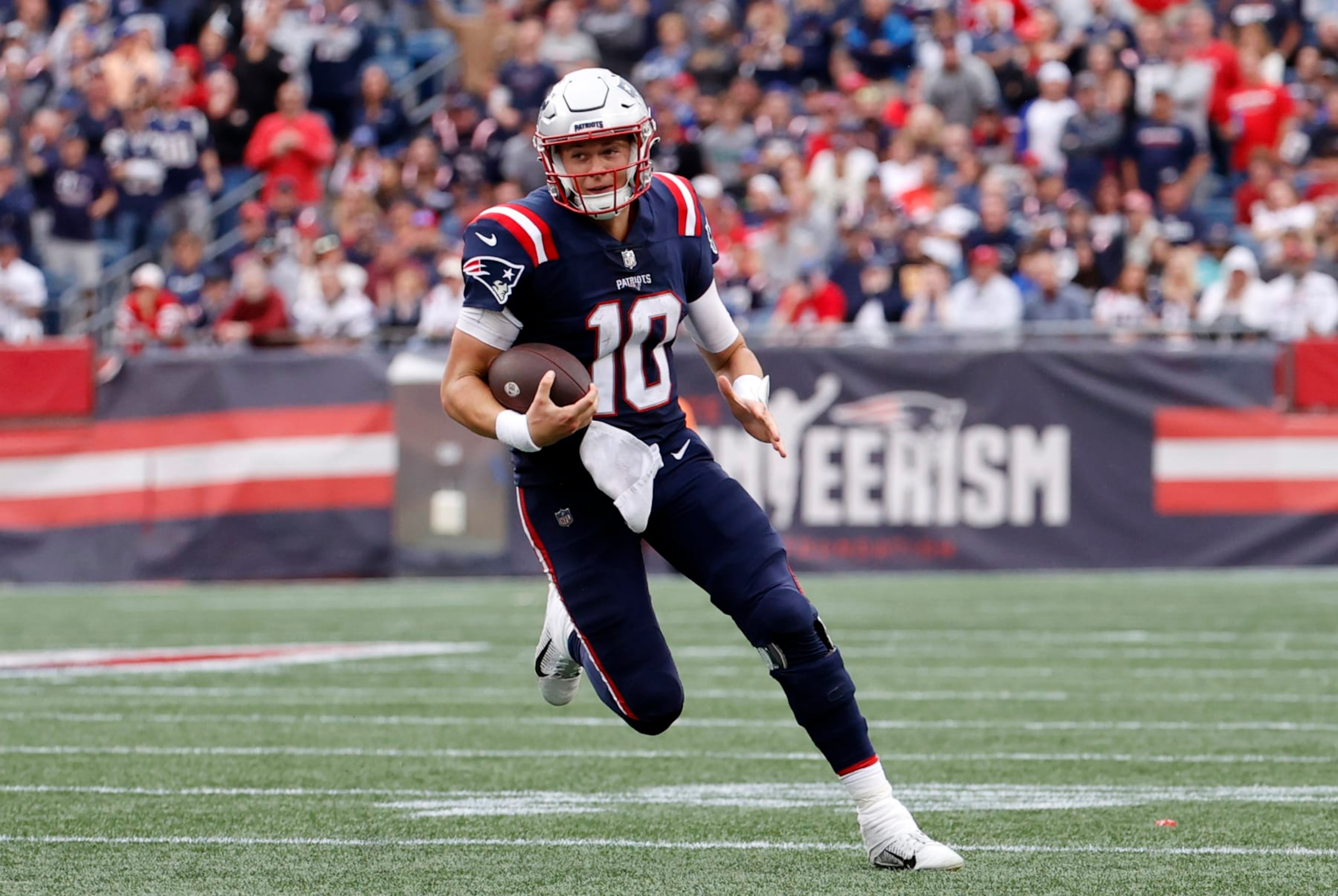 FOXBOROUGH, MA - SEPTEMBER 25: New England Patriots quarterback Mac Jones (10) carries the ball during a game between the New England Patriots and the Baltimore Ravens on September 25, 2022, at Gillette Stadium in Foxborough, Massachusetts. (Photo by Fred Kfoury III/Icon Sportswire via Getty Images)