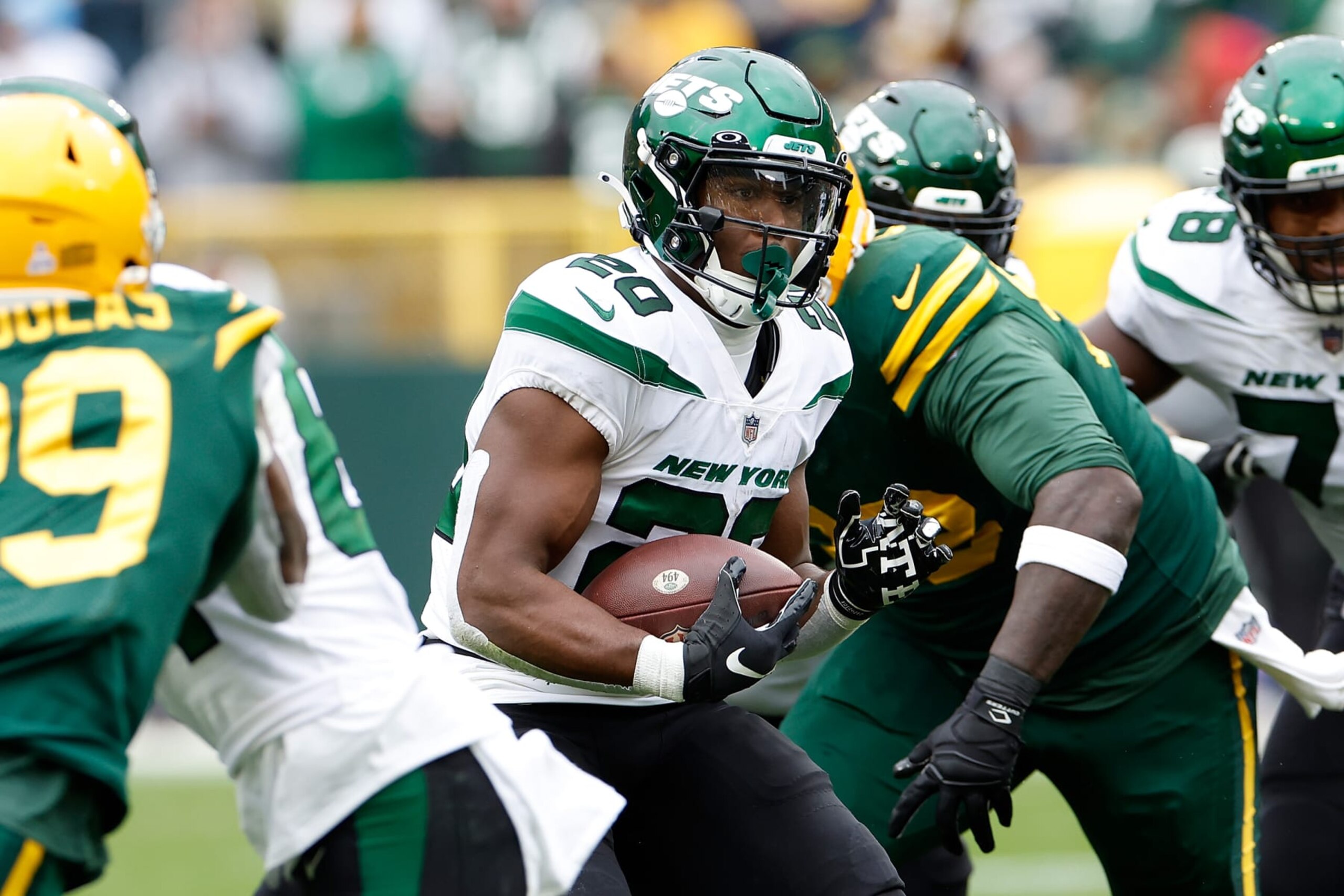 GREEN BAY, WISCONSIN - OCTOBER 16: Breece Hall #20 of the New York Jets rushes the ball against the Green Bay Packers at Lambeau Field on October 16, 2022 in Green Bay, Wisconsin. Jets defeated the Packers 27-10. (Photo by John Fisher/Getty Images)