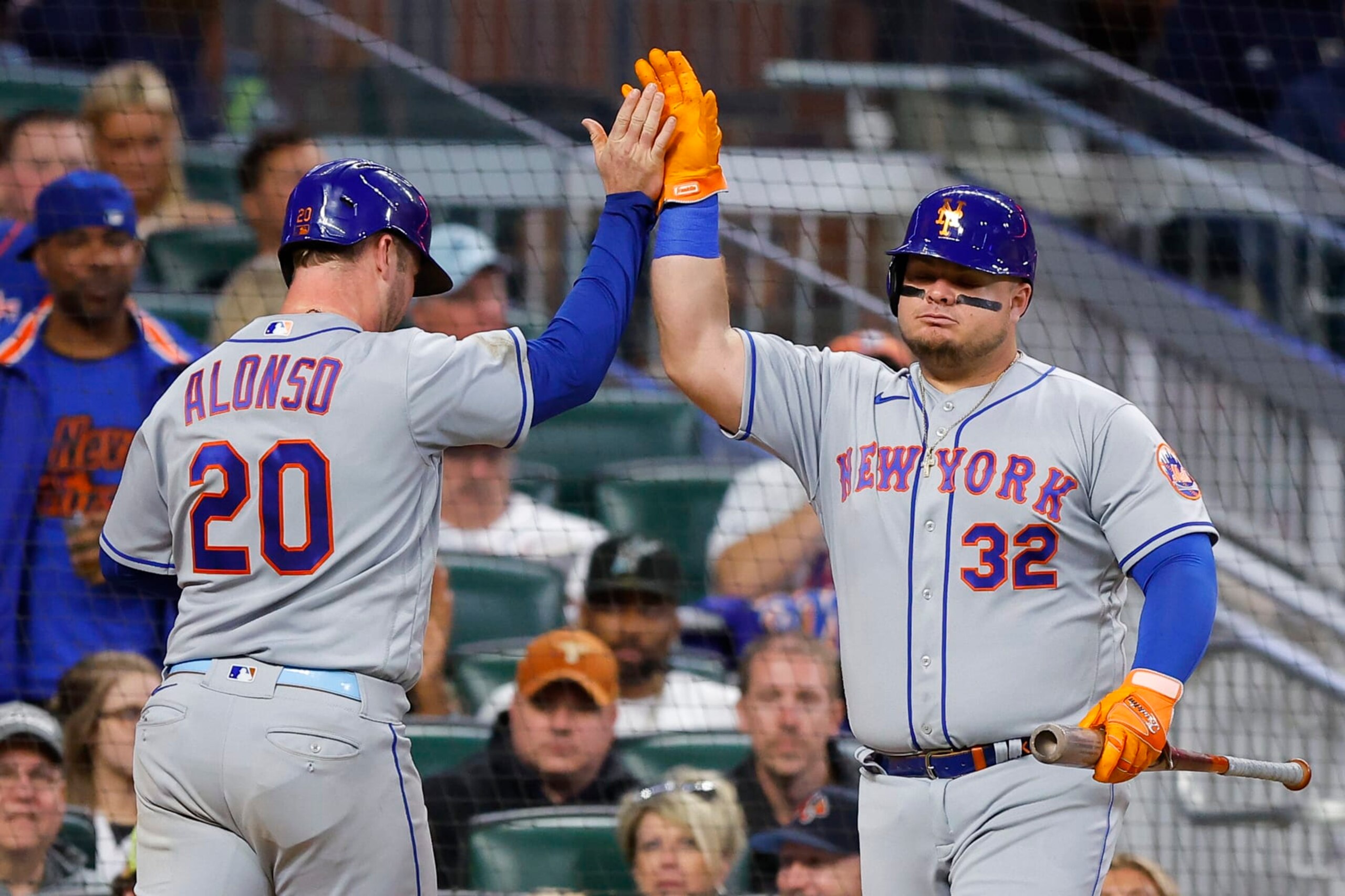 ATLANTA, GA - OCTOBER 01: Pete Alonso #20 celebrates scoring with Daniel Vogelbach #32 of the New York Mets during the fifth inning against the Atlanta Braves at Truist Park on October 1, 2022 in Atlanta, Georgia. (Photo by Todd Kirkland/Getty Images)