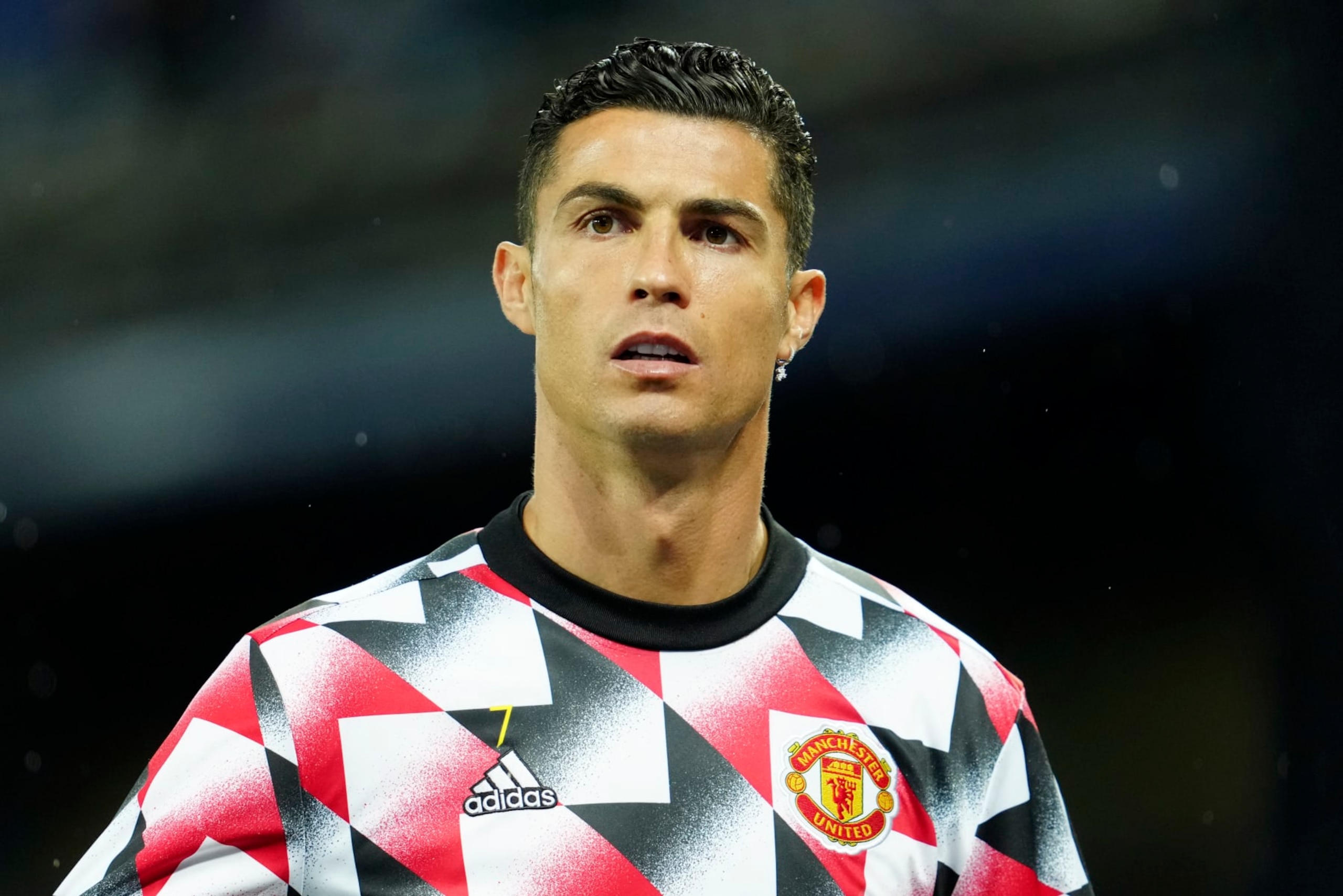 Manchester United's Cristiano Ronaldo walks on to the pitch for the warmup before the Premier League soccer match between Everton and Manchester United at Goodison Park, in Liverpool, England, Sunday Oct. 9, 2022. Ronaldo will start the match on the bench. (AP Photo/Jon Super)