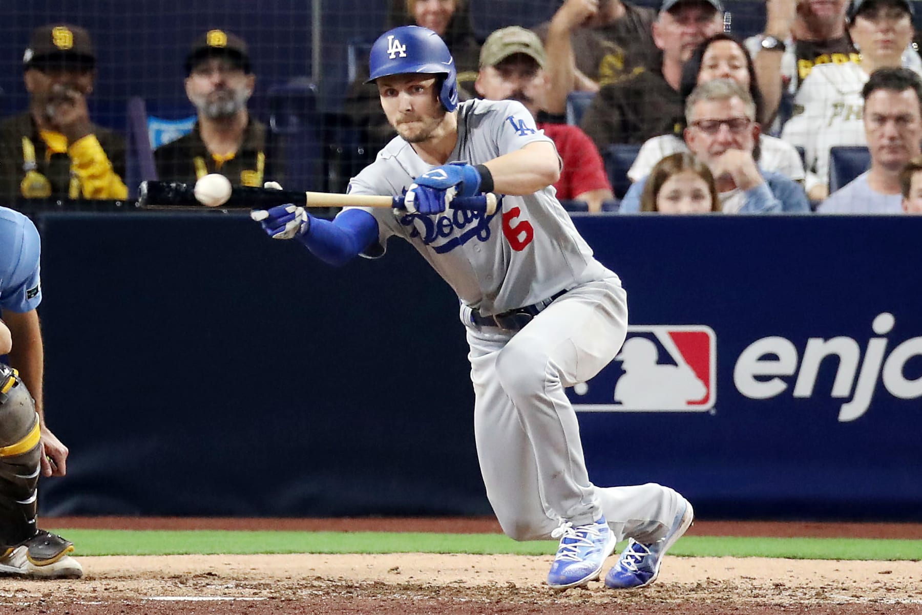SAN DIEGO, CALIFORNIA - OCTOBER 15: Trea Turner #6 of the Los Angeles Dodgers bunts for a single during the seventh inning against the San Diego Padres in game four of the National League Division Series at PETCO Park on October 15, 2022 in San Diego, California. (Photo by Denis Poroy/Getty Images)