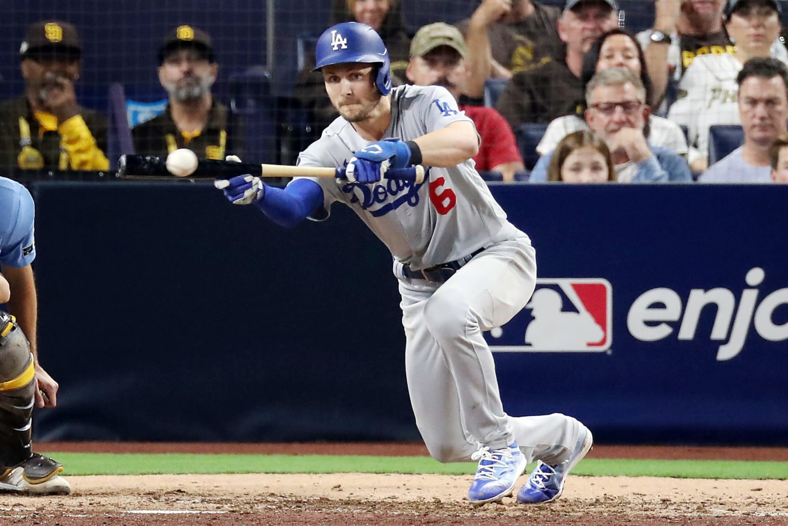 SAN DIEGO, CALIFORNIA - OCTOBER 15: Trea Turner #6 of the Los Angeles Dodgers bunts for a single during the seventh inning against the San Diego Padres in game four of the National League Division Series at PETCO Park on October 15, 2022 in San Diego, California. (Photo by Denis Poroy/Getty Images)