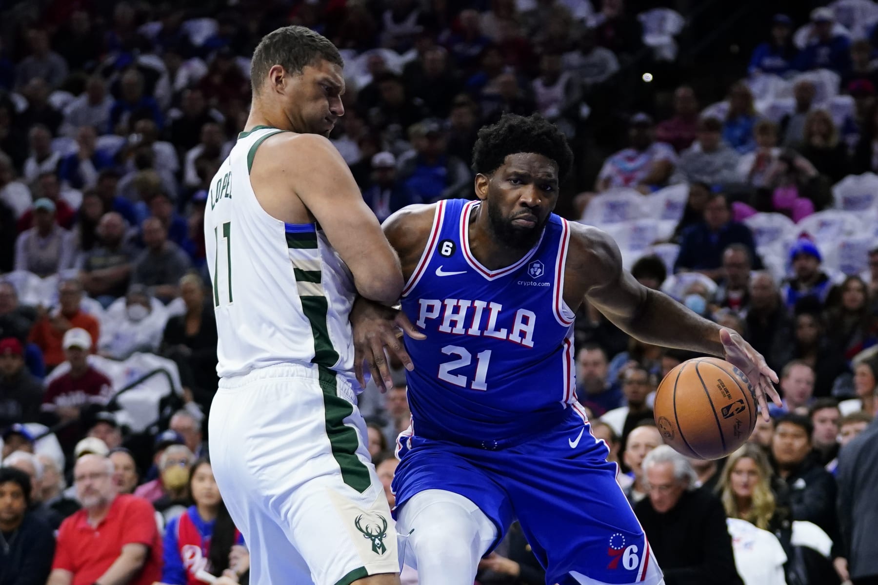 Philadelphia 76ers' Joel Embiid, right, tries to get past Milwaukee Bucks' Brook Lopez during the first half of an NBA basketball game, Thursday, Oct. 20, 2022, in Philadelphia. (AP Photo/Matt Slocum)