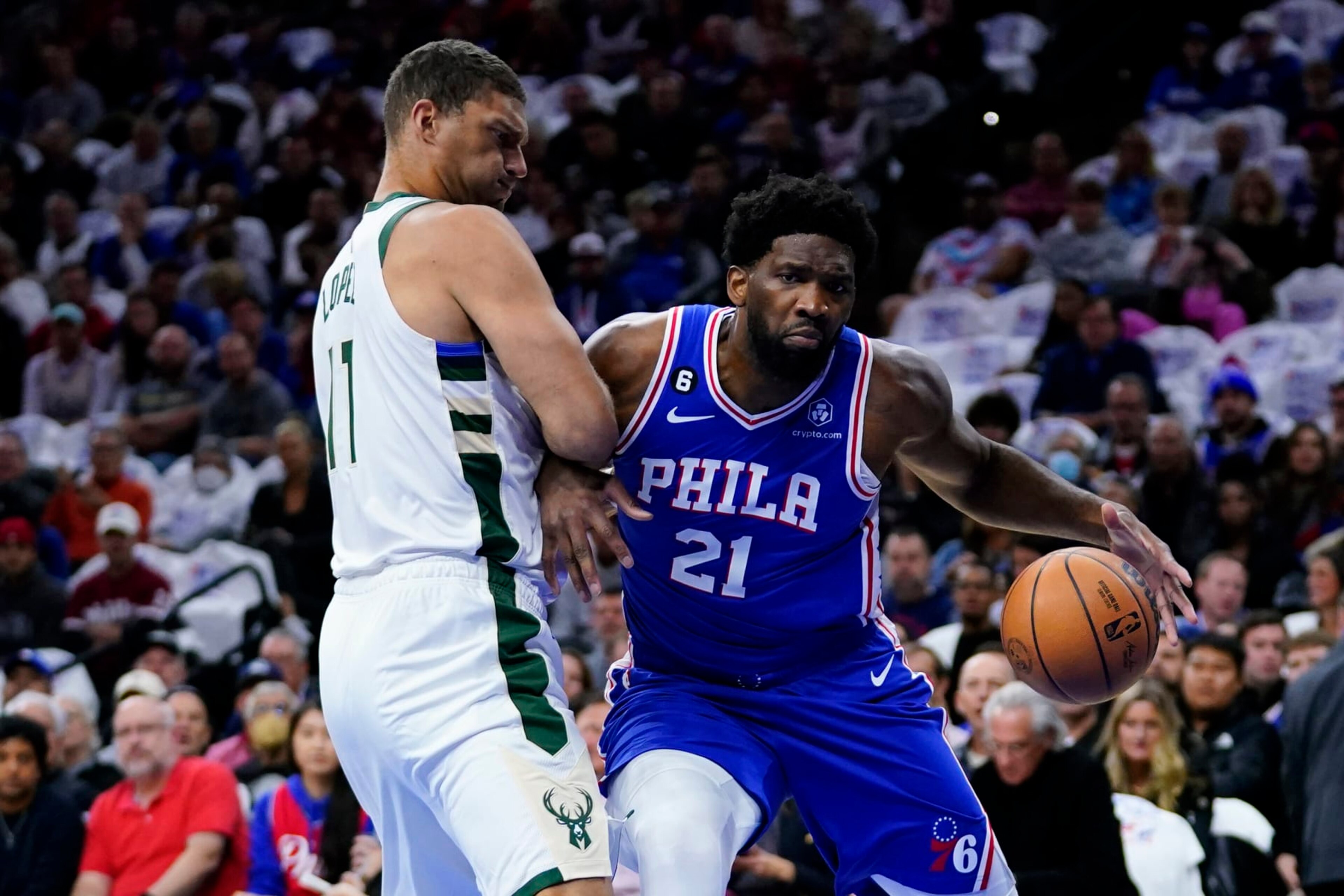 Philadelphia 76ers' Joel Embiid, right, tries to get past Milwaukee Bucks' Brook Lopez during the first half of an NBA basketball game, Thursday, Oct. 20, 2022, in Philadelphia. (AP Photo/Matt Slocum)