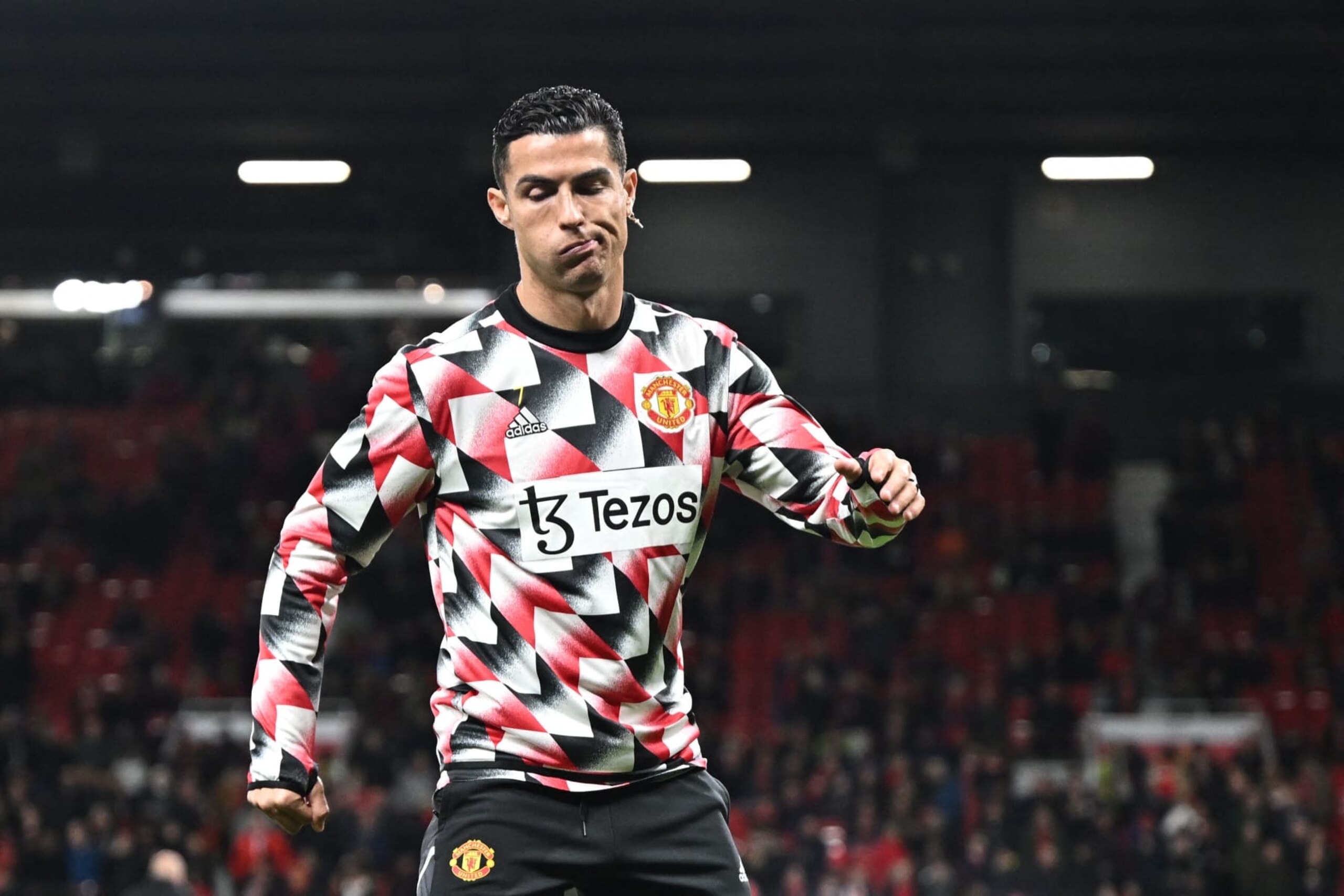 TOPSHOT - Manchester United's Portuguese striker Cristiano Ronaldo reacts during the warm up prior to the English Premier League football match between Manchester United and Tottenham Hotspur at Old Trafford in Manchester, north west England, on October 19, 2022. - RESTRICTED TO EDITORIAL USE. No use with unauthorized audio, video, data, fixture lists, club/league logos or 'live' services. Online in-match use limited to 120 images. An additional 40 images may be used in extra time. No video emulation. Social media in-match use limited to 120 images. An additional 40 images may be used in extra time. No use in betting publications, games or single club/league/player publications. (Photo by Oli SCARFF / AFP) / RESTRICTED TO EDITORIAL USE. No use with unauthorized audio, video, data, fixture lists, club/league logos or 'live' services. Online in-match use limited to 120 images. An additional 40 images may be used in extra time. No video emulation. Social media in-match use limited to 120 images. An additional 40 images may be used in extra time. No use in betting publications, games or single club/league/player publications. / RESTRICTED TO EDITORIAL USE. No use with unauthorized audio, video, data, fixture lists, club/league logos or 'live' services. Online in-match use limited to 120 images. An additional 40 images may be used in extra time. No video emulation. Social media in-match use limited to 120 images. An additional 40 images may be used in extra time. No use in betting publications, games or single club/league/player publications. (Photo by OLI SCARFF/AFP via Getty Images)