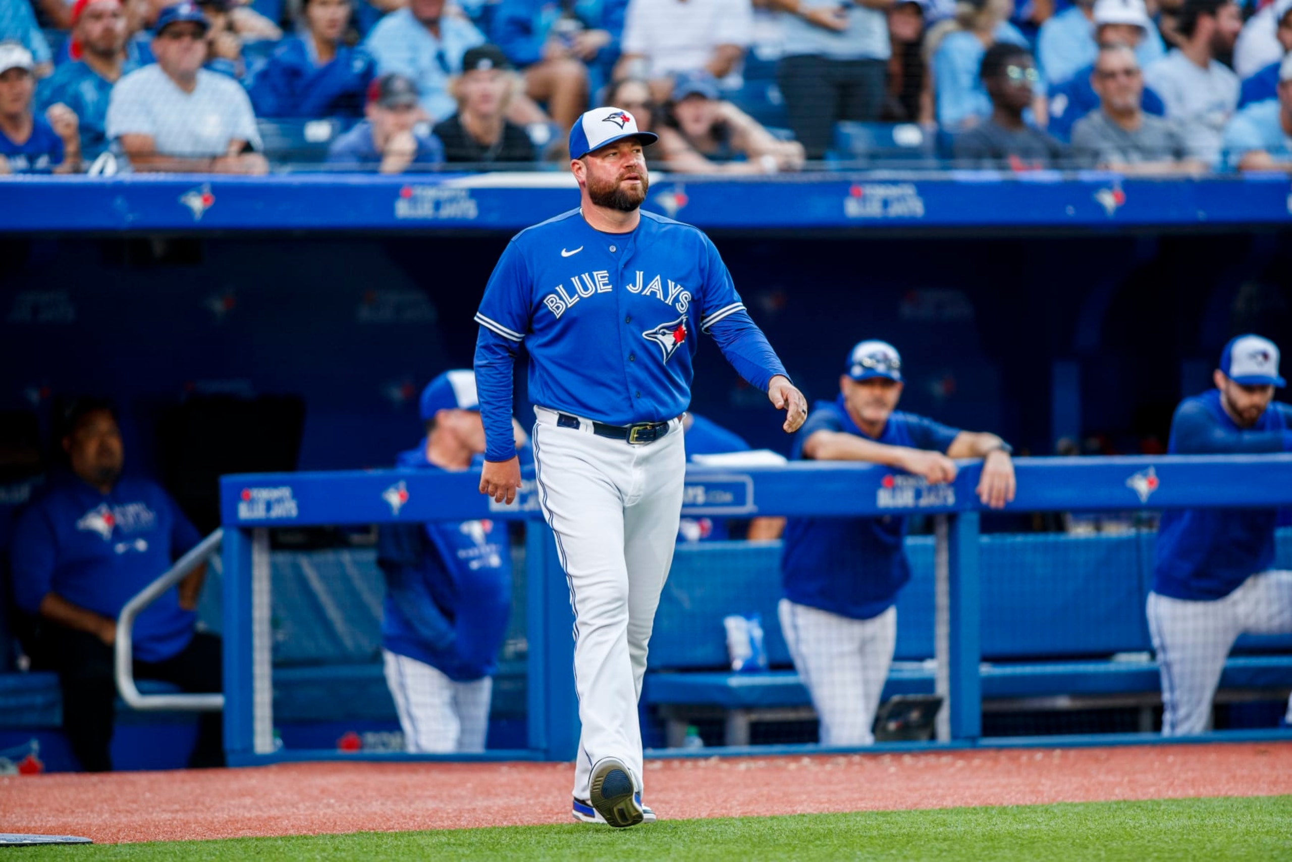 TORONTO, ON - AUGUST 27: John Schneider #14, manager of the Toronto Blue Jays talks with umpire umpire Shane Livensparger #43 after getting tossed in the eighth inning of their MLB game against the Los Angeles Angels at Rogers Centre on August 27, 2022 in Toronto, Canada. (Photo by Cole Burston/Getty Images)