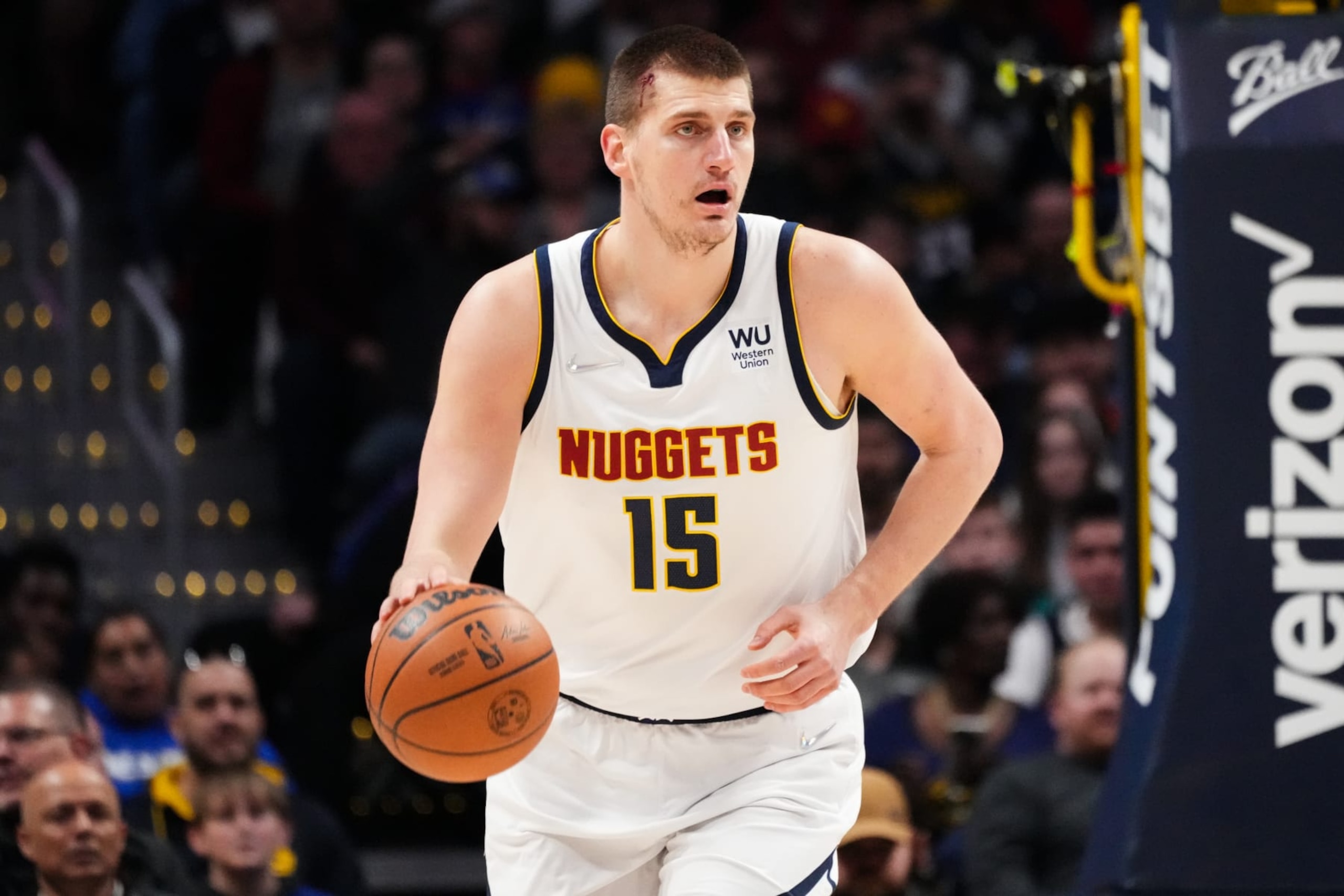 DENVER, CO - APRIL 07: Nikola Jokic #15 of the Denver Nuggets dribbles up the court while bleeding against the Memphis Grizzlies at Ball Arena on April 7, 2022 in Denver, Colorado. NOTE TO USER: User expressly acknowledges and agrees that, by downloading and or using this photograph, User is consenting to the terms and conditions of the Getty Images License Agreement. (Photo by Ethan Mito/Clarkson Creative/Getty Images)