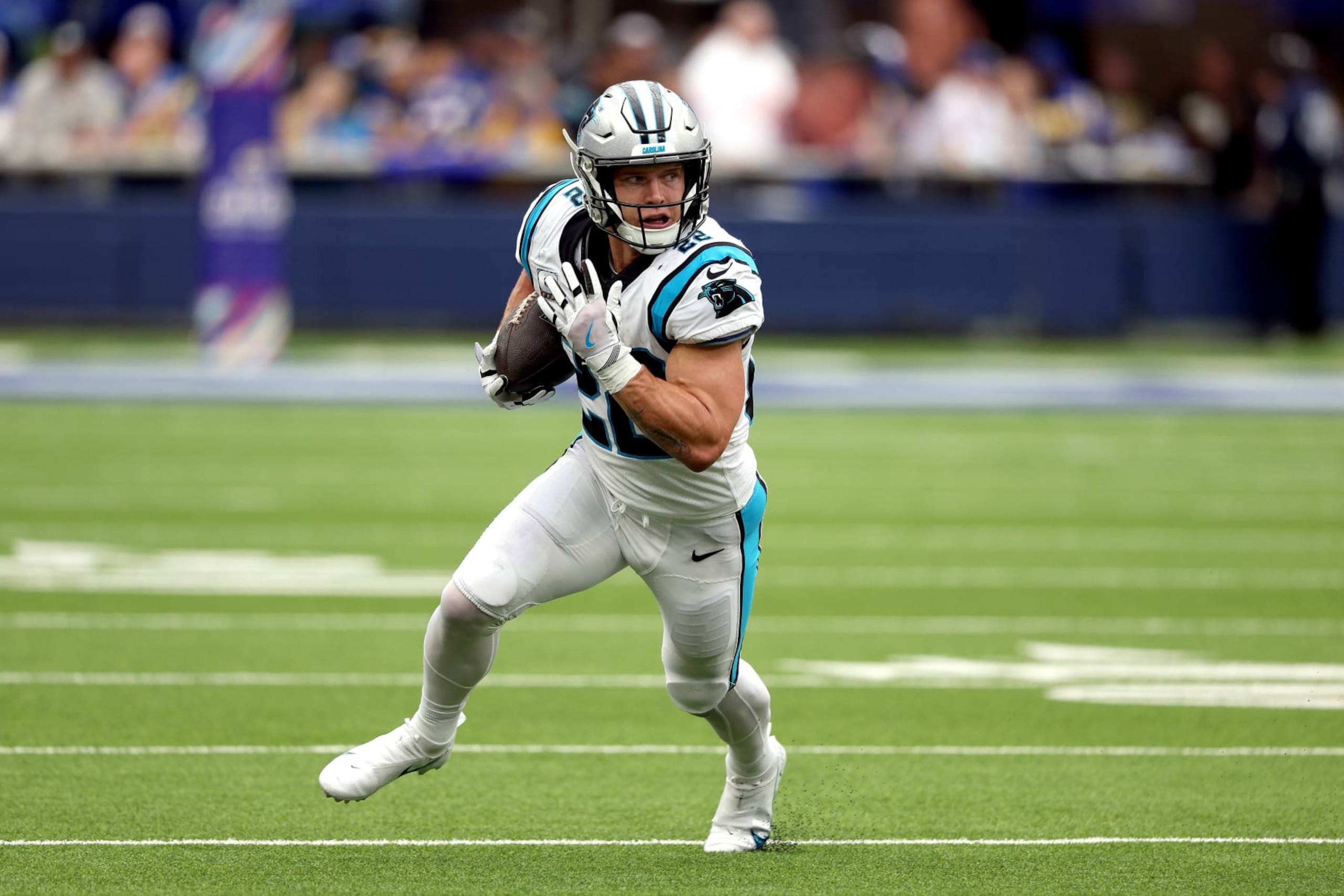 INGLEWOOD, CALIFORNIA - OCTOBER 16: Christian McCaffrey #22 of the Carolina Panthers runs the ball in the first quarter during a game against the Los Angeles Rams at SoFi Stadium on October 16, 2022 in Inglewood, California. (Photo by Harry How/Getty Images)