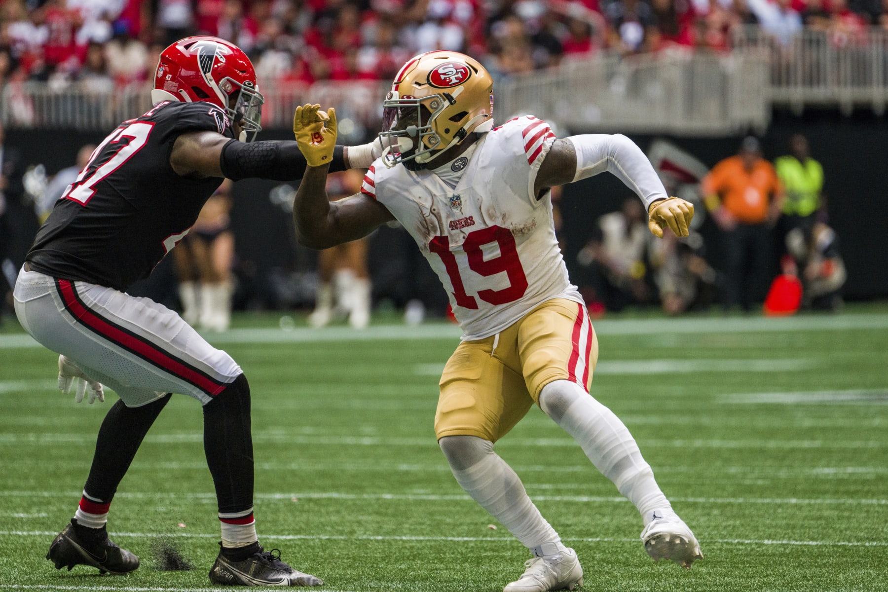 San Francisco 49ers wide receiver Deebo Samuel (19) works against Atlanta Falcons defensive end Arnold Ebiketie (47) during the second half of an NFL football game, Sunday, Oct. 16, 2022, in Atlanta. The Atlanta Falcons won 28-14. (AP Photo/Danny Karnik)