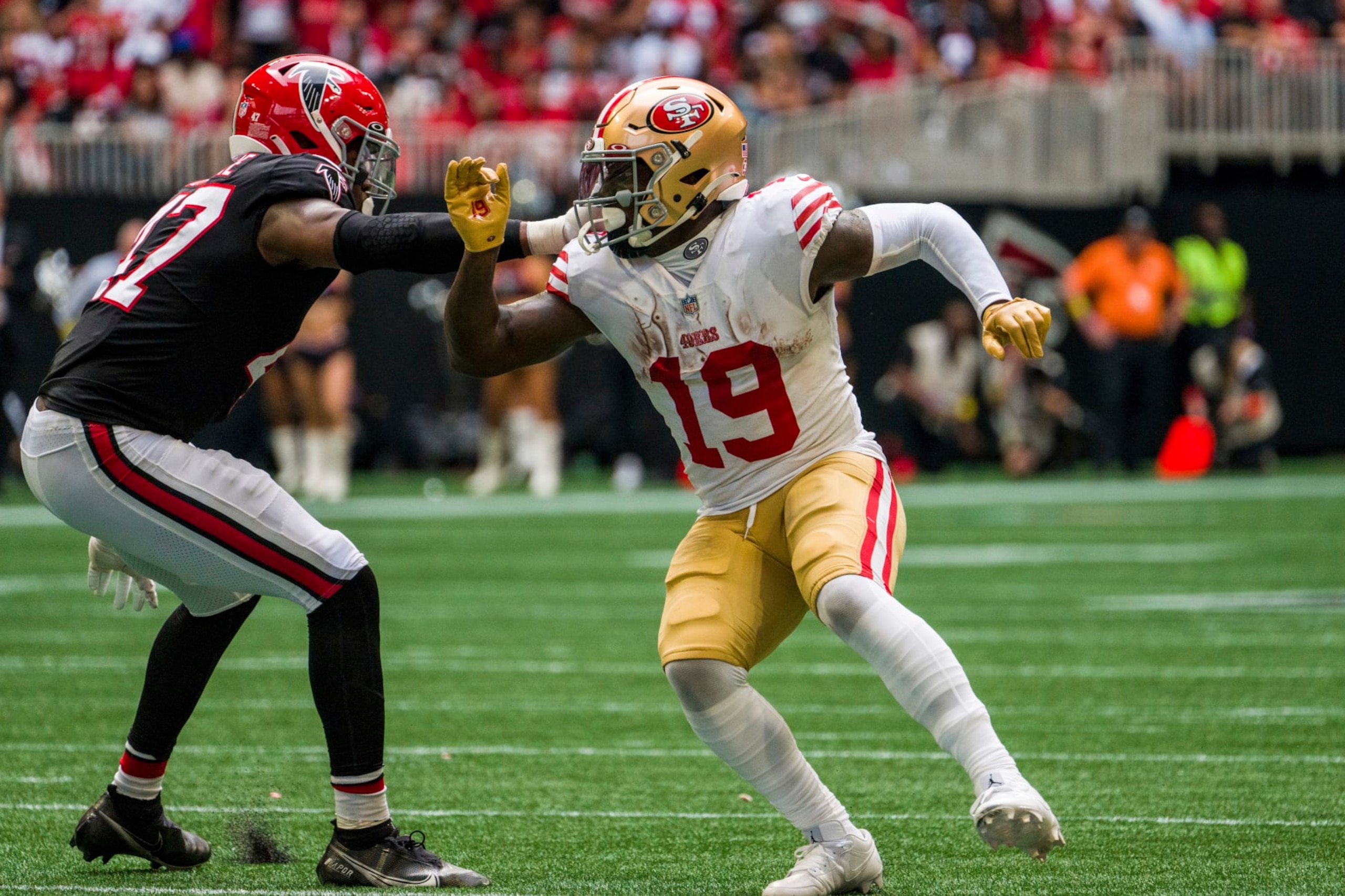 San Francisco 49ers wide receiver Deebo Samuel (19) works against Atlanta Falcons defensive end Arnold Ebiketie (47) during the second half of an NFL football game, Sunday, Oct. 16, 2022, in Atlanta. The Atlanta Falcons won 28-14. (AP Photo/Danny Karnik)