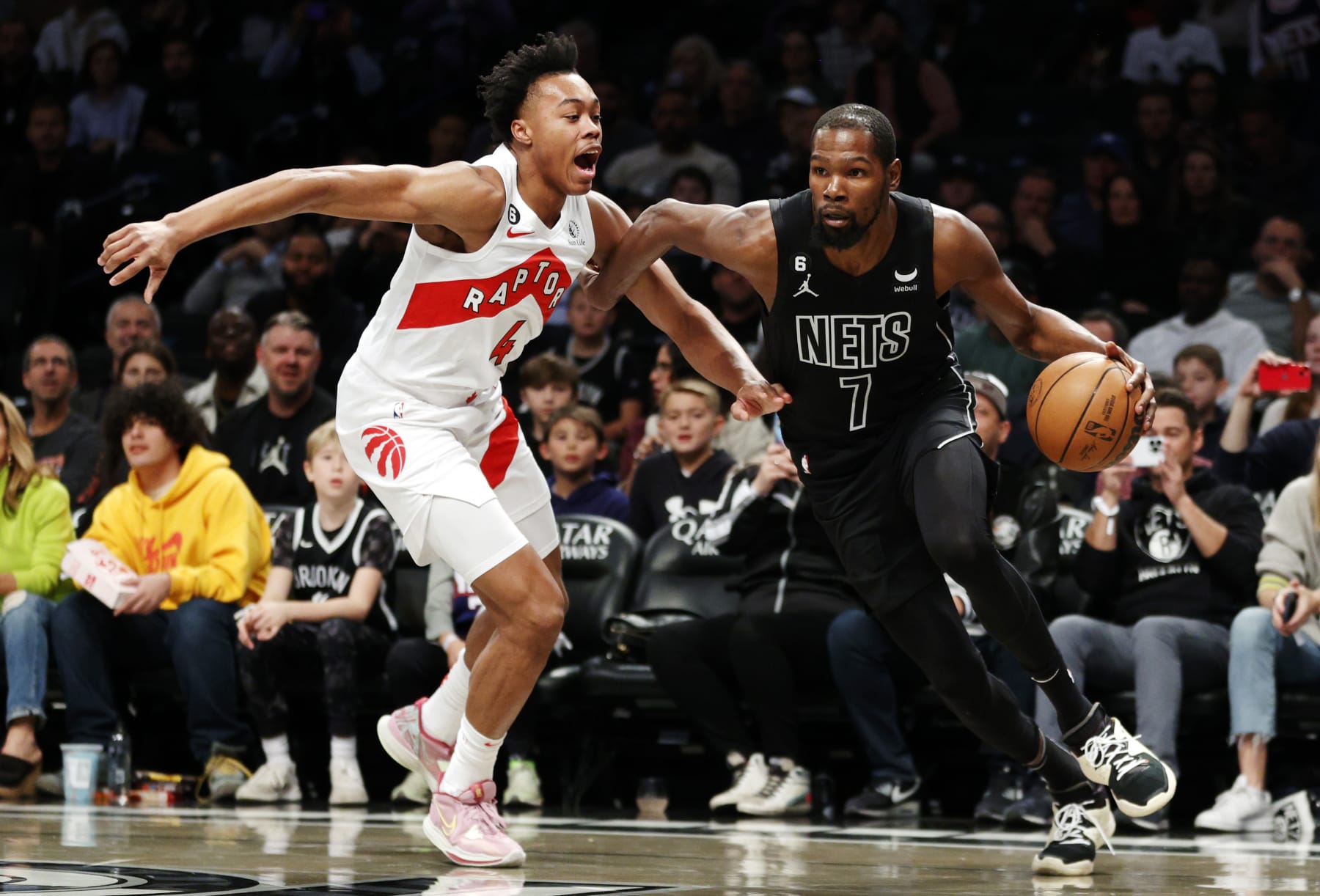 NEW YORK, NEW YORK - OCTOBER 21: Kevin Durant #7 of the Brooklyn Nets dribbles as Scottie Barnes #4 of the Toronto Raptors defends during the first half at Barclays Center on October 21, 2022 in the Brooklyn borough of New York City. NOTE TO USER: User expressly acknowledges and agrees that, by downloading and or using this photograph, User is consenting to the terms and conditions of the Getty Images License Agreement. (Photo by Sarah Stier/Getty Images)