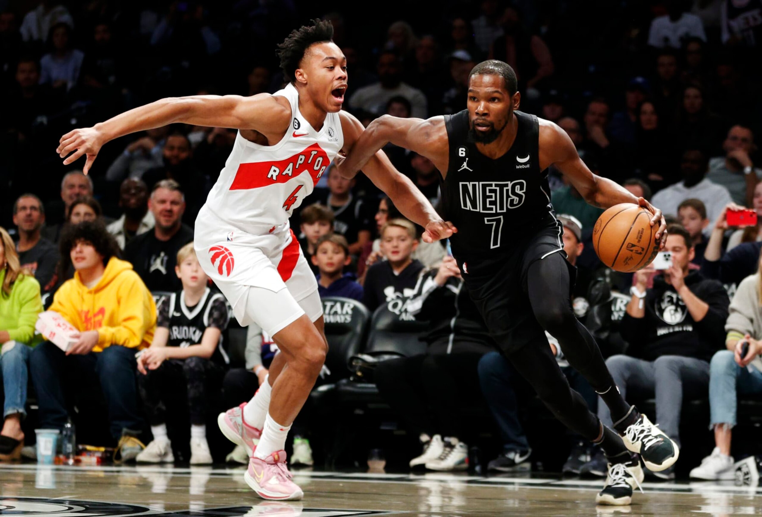NEW YORK, NEW YORK - OCTOBER 21: Kevin Durant #7 of the Brooklyn Nets dribbles as Scottie Barnes #4 of the Toronto Raptors defends during the first half at Barclays Center on October 21, 2022 in the Brooklyn borough of New York City. NOTE TO USER: User expressly acknowledges and agrees that, by downloading and or using this photograph, User is consenting to the terms and conditions of the Getty Images License Agreement. (Photo by Sarah Stier/Getty Images)