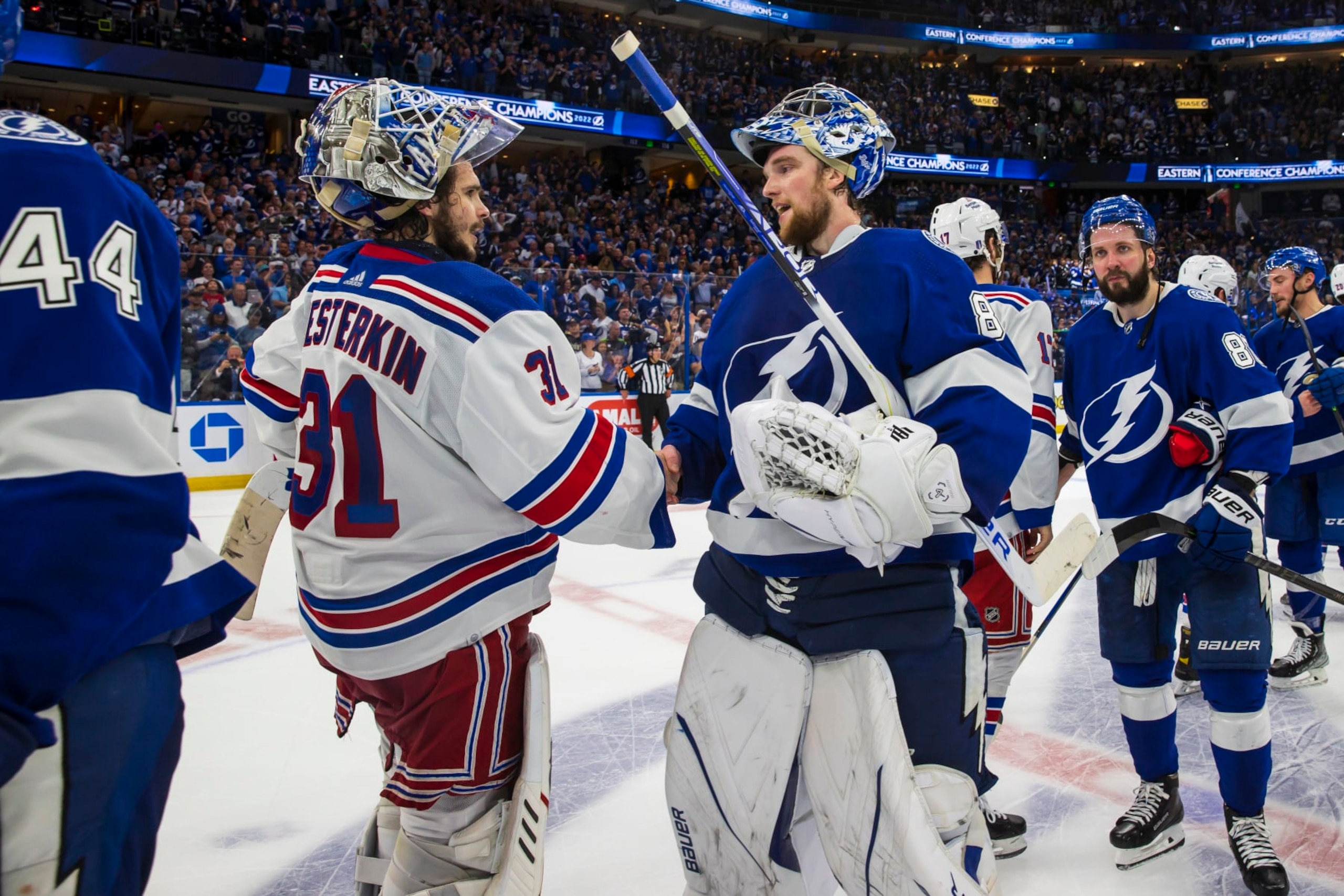 TAMPA, FL - JUNE 11: Goalie Andrei Vasilevskiy #88 of the Tampa Bay Lightning shakes hands with Igor Shesterkin #31 of the New York Rangers after Game Six of the Eastern Conference Final of the 2022 Stanley Cup Playoffs at Amalie Arena on June 11, 2022 in Tampa, Florida. (Photo by Mark LoMoglio/NHLI via Getty Images)