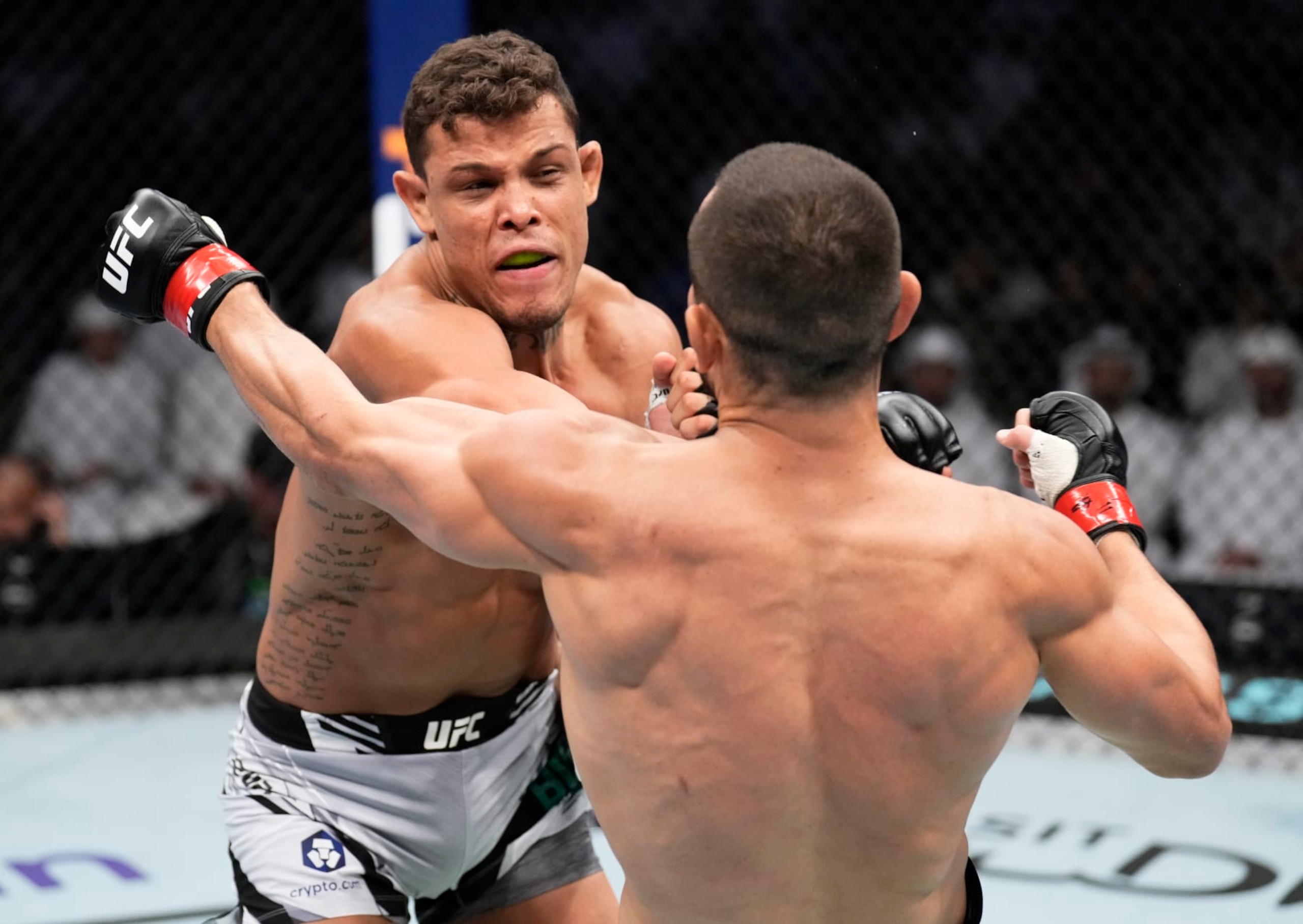 ABU DHABI, UNITED ARAB EMIRATES - OCTOBER 22: (L-R) Caio Borralho of Brazil punches Makhmud Muradov of Tajikistan in a middleweight fight during the UFC 280 event at Etihad Arena on October 22, 2022 in Abu Dhabi, United Arab Emirates. (Photo by Chris Unger/Zuffa LLC)