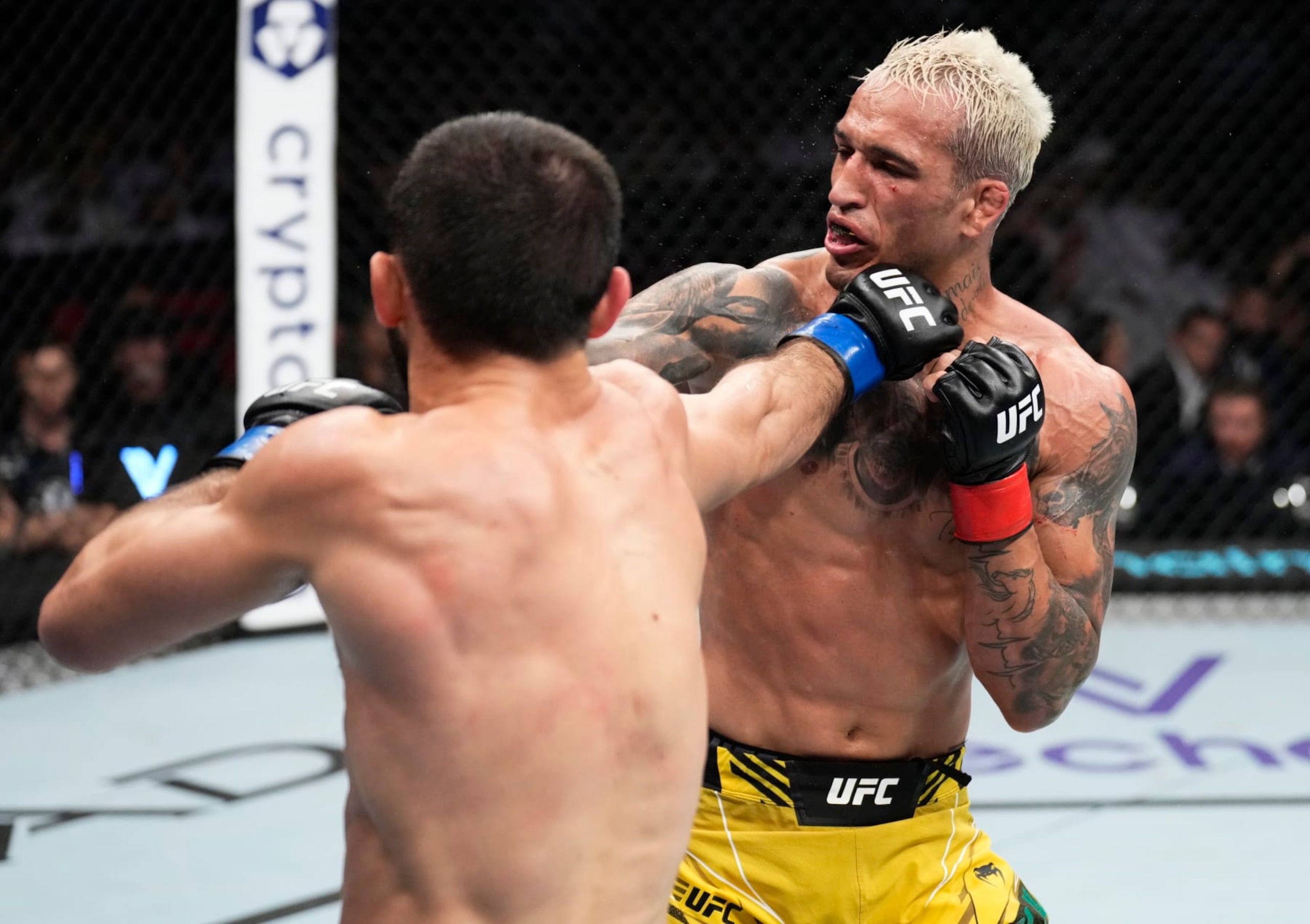 ABU DHABI, UNITED ARAB EMIRATES - OCTOBER 22: (L-R) Islam Makhachev of Russia punches Charles Oliveira of Brazil in their UFC lightweight championship fight during the UFC 280 event at Etihad Arena on October 22, 2022 in Abu Dhabi, United Arab Emirates. (Photo by Chris Unger/Zuffa LLC)