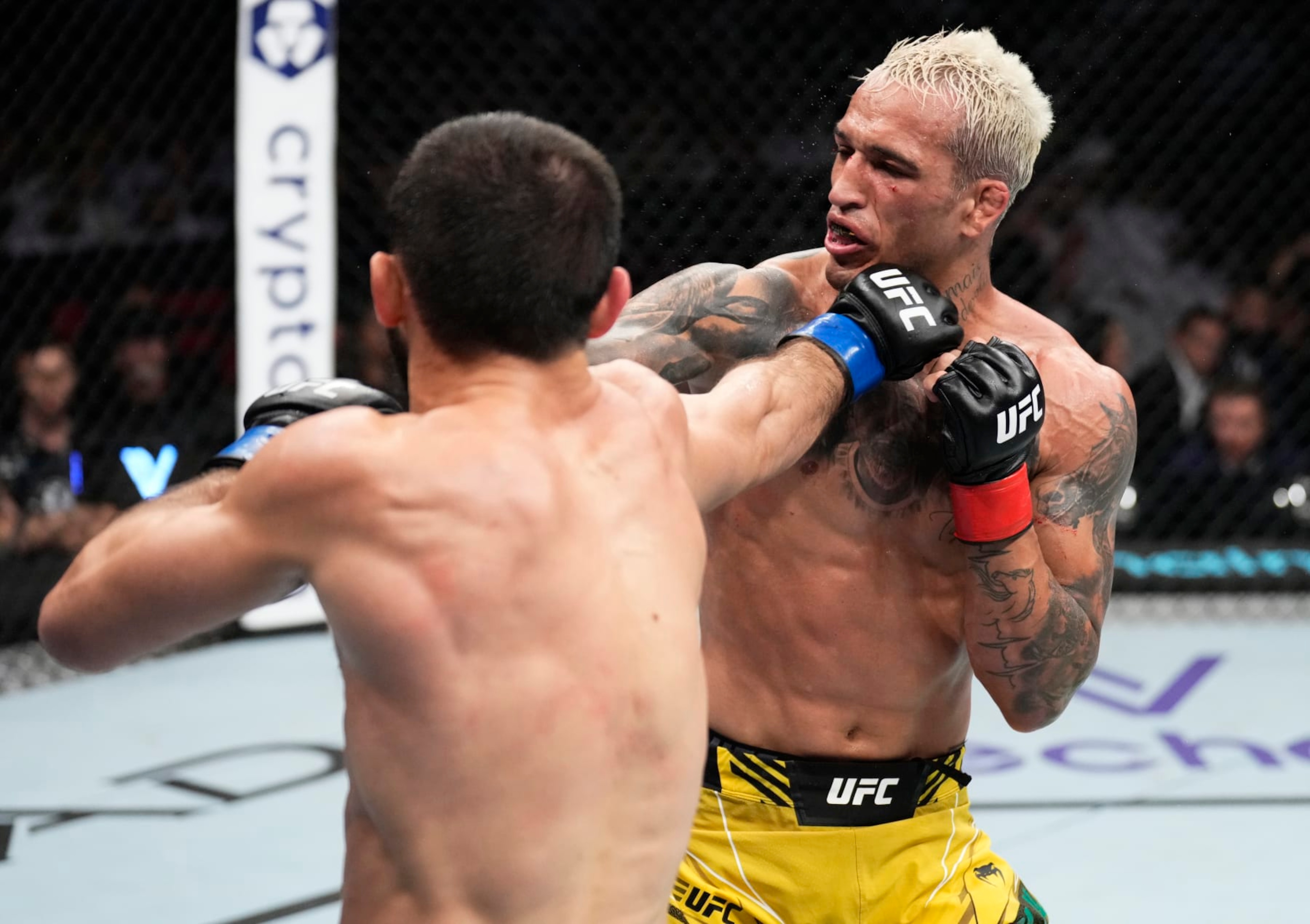 ABU DHABI, UNITED ARAB EMIRATES - OCTOBER 22: (L-R) Islam Makhachev of Russia punches Charles Oliveira of Brazil in their UFC lightweight championship fight during the UFC 280 event at Etihad Arena on October 22, 2022 in Abu Dhabi, United Arab Emirates. (Photo by Chris Unger/Zuffa LLC)