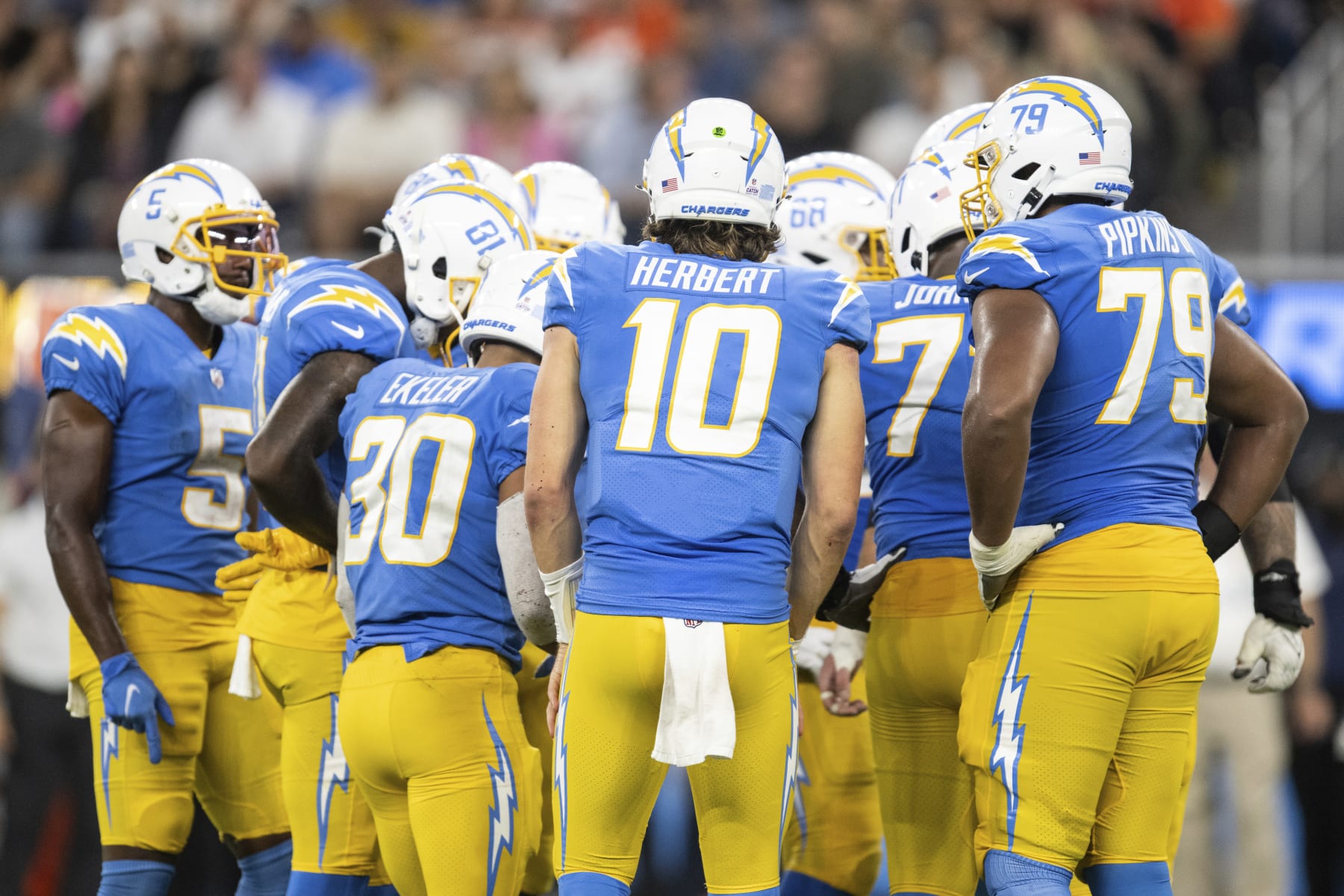 Los Angeles Chargers quarterback Justin Herbert (10) leads a huddle during an NFL football game against the Denver Broncos, Monday, Oct. 17, 2022, in Inglewood, Calif. (AP Photo/Kyusung Gong)