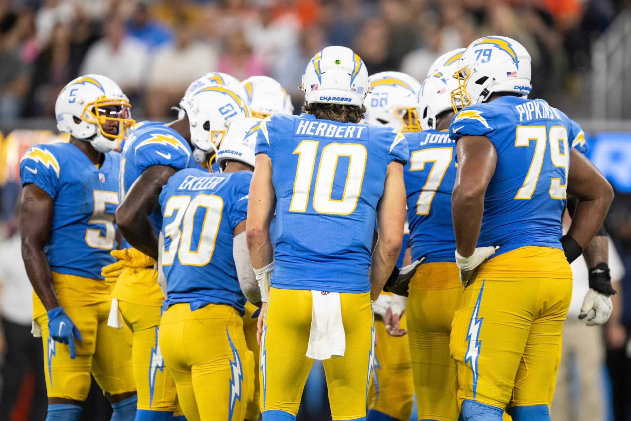 Los Angeles Chargers quarterback Justin Herbert (10) leads a huddle during an NFL football game against the Denver Broncos, Monday, Oct. 17, 2022, in Inglewood, Calif. (AP Photo/Kyusung Gong)