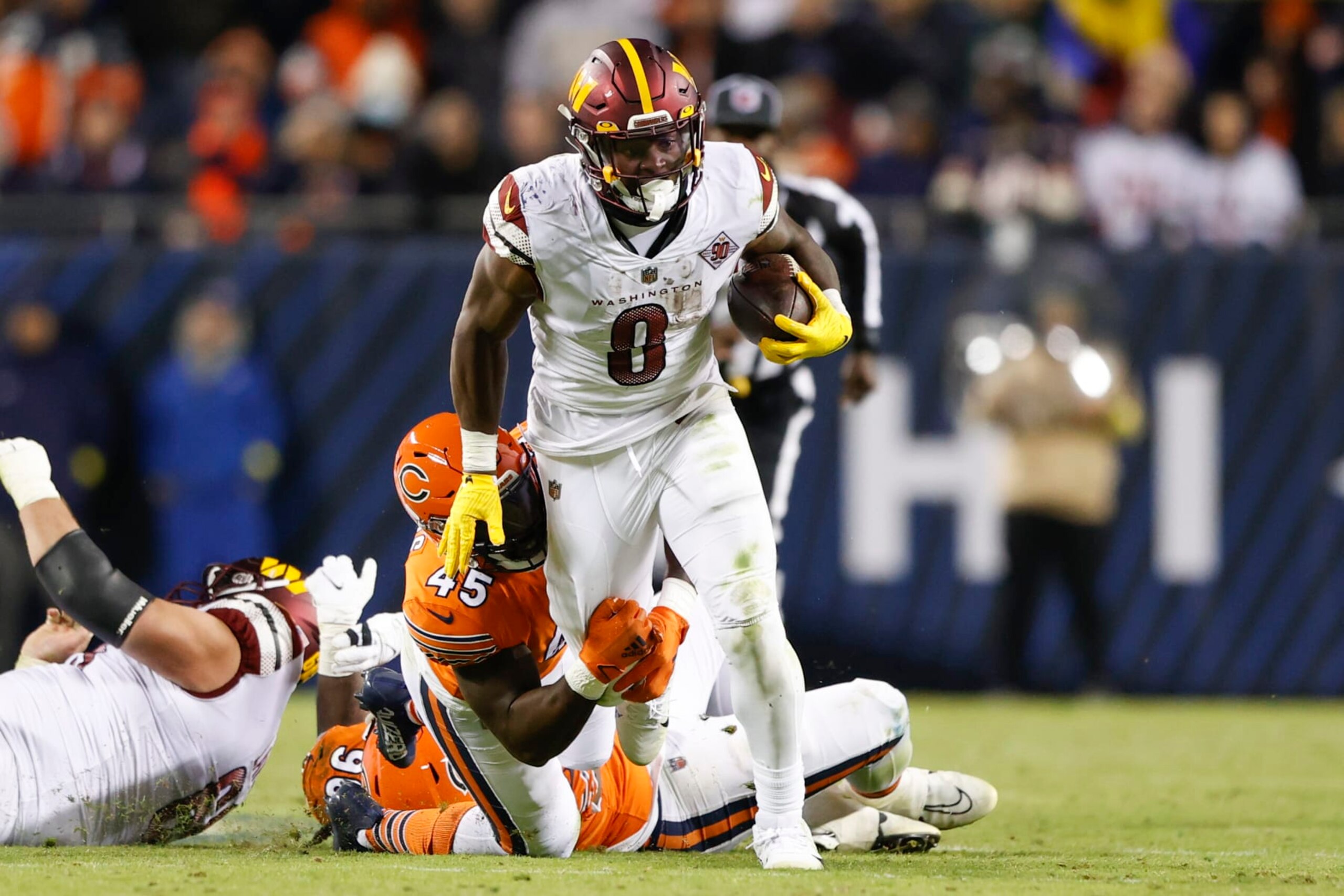 Washington Commanders running back Brian Robinson (8) is tackled by Chicago Bears linebacker Joe Thomas (45) during the second half of an NFL football game, Thursday, Oct. 13, 2022, in Chicago. (AP Photo/Kamil Krzaczynski)