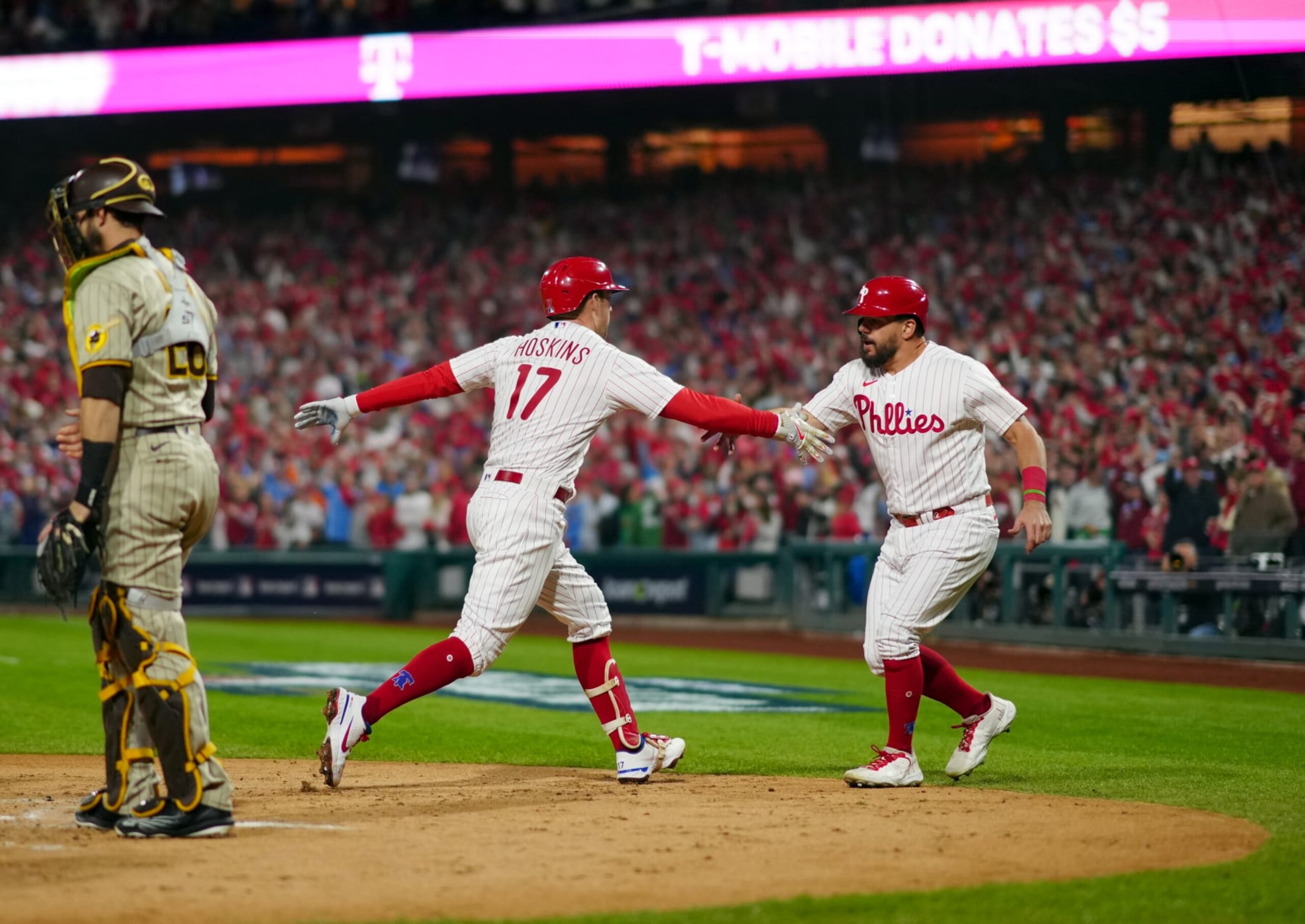 PHILADELPHIA, PA - OCTOBER 22: Rhys Hoskins #17 and Kyle Schwarber #12 of the Philadelphia Phillies celebrates after scoring on Hoskins two-run home run in the first inning of Game 4 of the NLCS between the San Diego Padres and the Philadelphia Phillies at Citizens Bank Park on Saturday, October 22, 2022 in Philadelphia, Pennsylvania. (Photo by Daniel Shirey/MLB Photos via Getty Images)