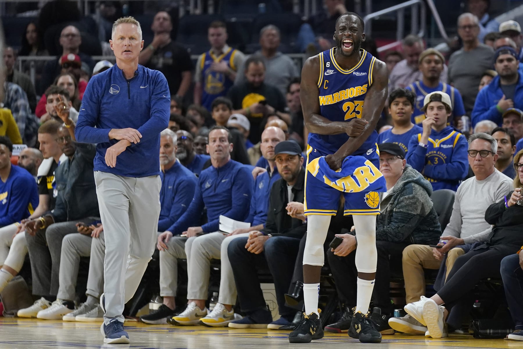 Golden State Warriors coach Steve Kerr, left, and forward Draymond Green (23) react after an official's call during the second half of the team's NBA basketball game against the Denver Nuggets in San Francisco, Friday, Oct. 21, 2022. (AP Photo/Jeff Chiu)