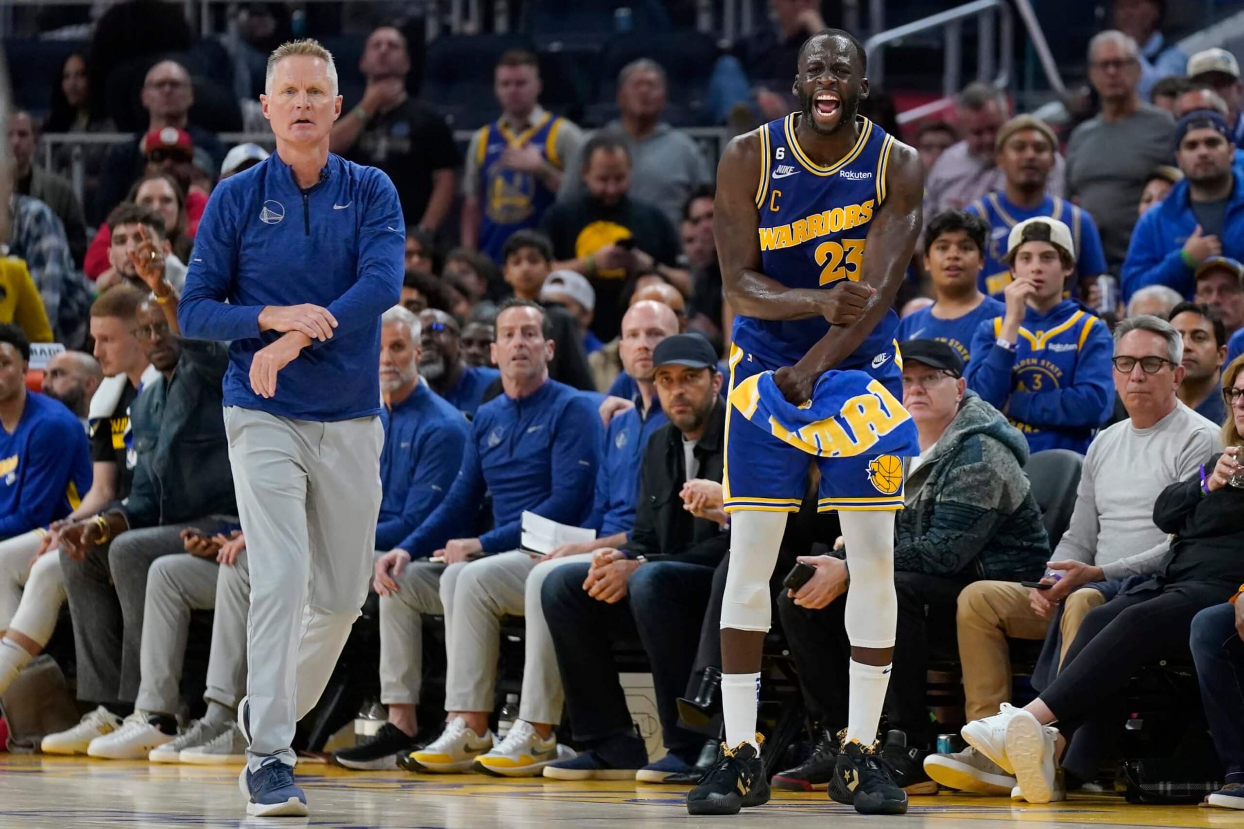 Golden State Warriors coach Steve Kerr, left, and forward Draymond Green (23) react after an official's call during the second half of the team's NBA basketball game against the Denver Nuggets in San Francisco, Friday, Oct. 21, 2022. (AP Photo/Jeff Chiu)