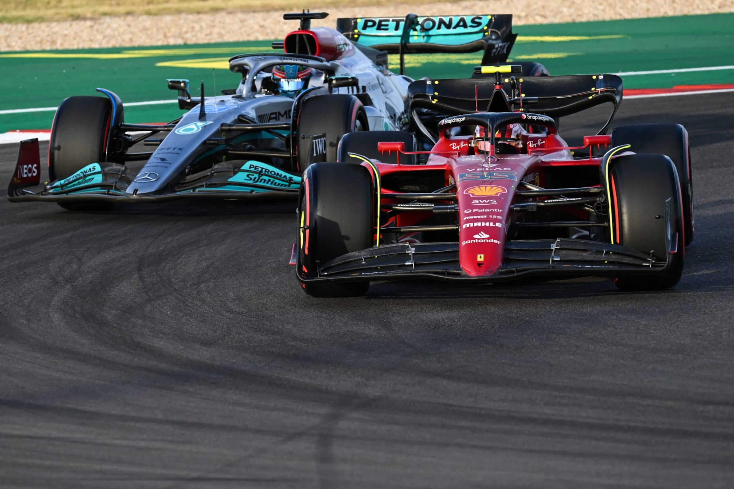 Ferrari's Spanish driver Carlos Sainz Jr and Mercedes' British driver George Russell (L) make a turn during the qualifying session for the Formula One United States Grand Prix, at the Circuit of the Americas in Austin, Texas, on October 22, 2022. (Photo by Patrick T. FALLON / AFP) (Photo by PATRICK T. FALLON/AFP via Getty Images)