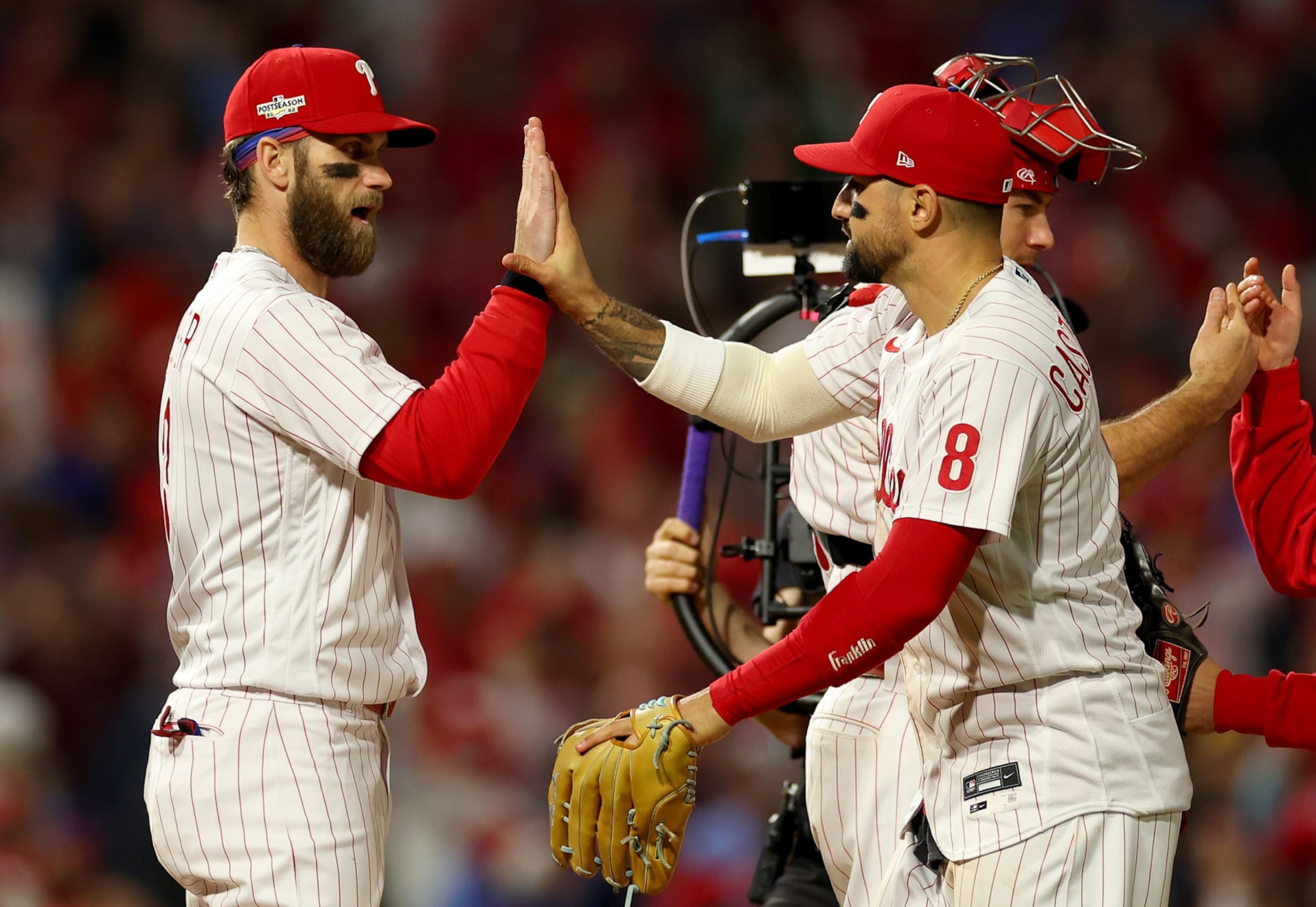 PHILADELPHIA, PENNSYLVANIA - OCTOBER 22: Bryce Harper #3 and Nick Castellanos #8 of the Philadelphia Phillies celebrate their 10-6 win against the San Diego Padres in game four of the National League Championship Series at Citizens Bank Park on October 22, 2022 in Philadelphia, Pennsylvania. (Photo by Mike Ehrmann/Getty Images)