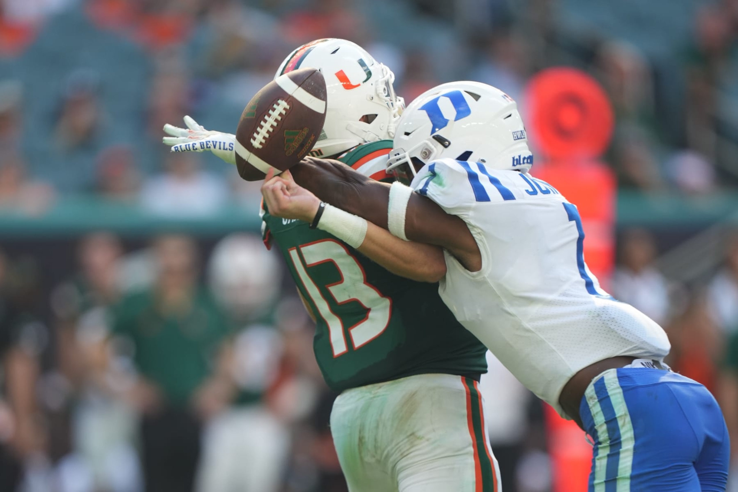 MIAMI GARDENS, FL - OCTOBER 22: Duke Blue Devils defensive back Darius Joiner (1) knocks the ball from Miami Hurricanes quarterback Jake Garcia (13) for a fumble and turnover during the game between the Duke Blue Devils and the Miami Hurricanes on Saturday, October 22, 2022 at Hard Rock Stadium, Miami Gardens, FL (Photo by Peter Joneleit/Icon Sportswire via Getty Images)