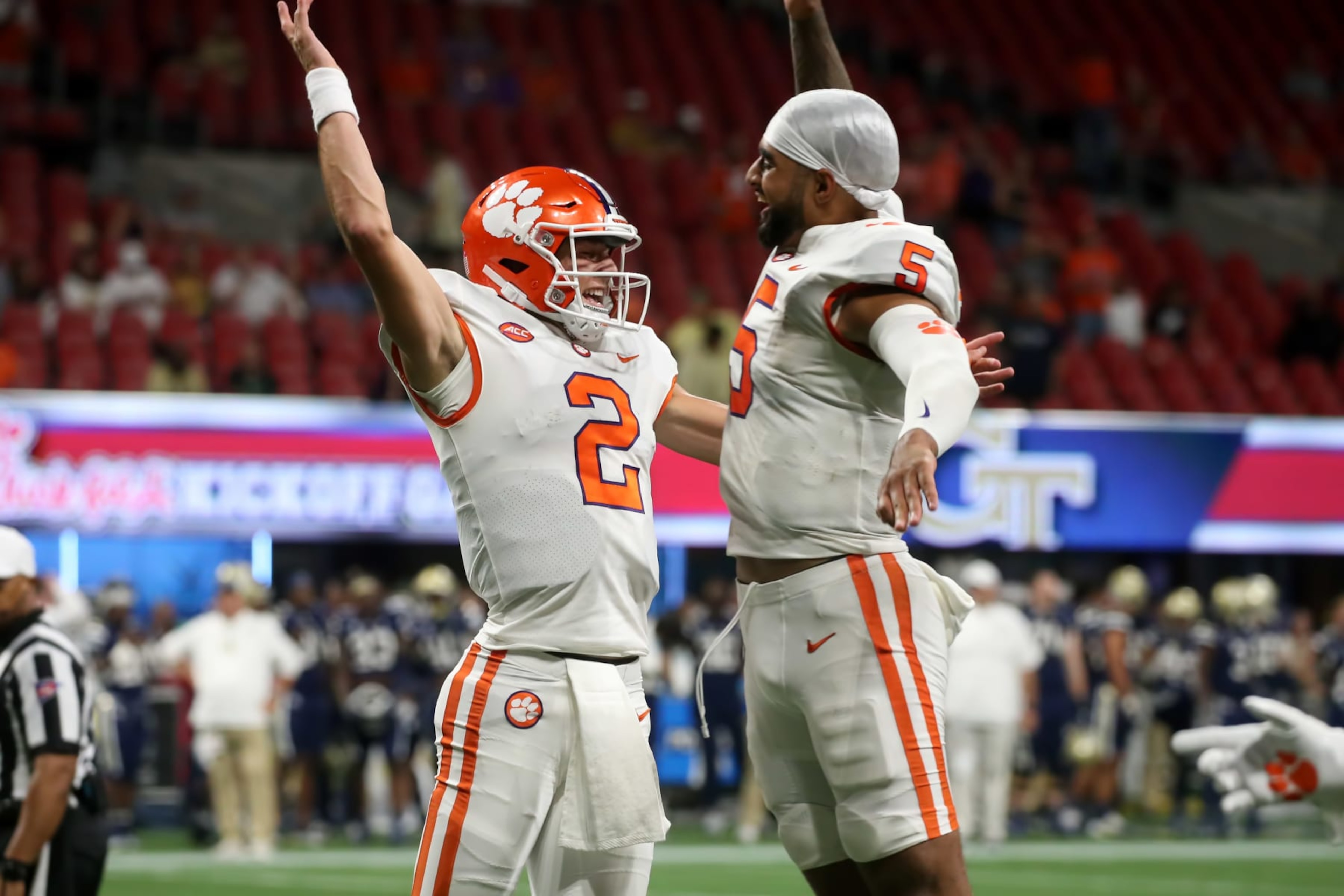 ATLANTA, GA - SEPTEMBER 05: Clemson Tigers quarterback Cade Klubnik (2) and Clemson Tigers quarterback DJ Uiagalelei (5) do a chest bump after a 4th quarter score during the game between the Clemson Tigers and the Georgia Tech Yellow Jackets on September 5, 2022 at Mercedes-Benz Stadium in Atlanta, Georgia. (Photo by Michael Wade/Icon Sportswire via Getty Images)