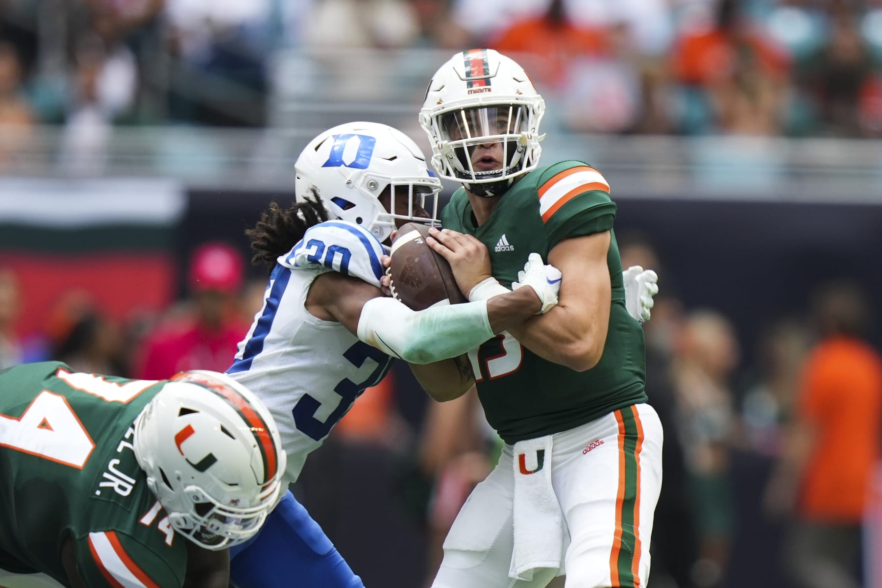 MIAMI GARDENS, FL - OCTOBER 22: Miami Hurricanes quarterback Jake Garcia (13) gets sacked by Duke Blue Devils defensive back Brandon Johnson (30) during the game between the Duke Blue Devils and the Miami Hurricanes on Saturday, October 22, 2022 at Hard Rock Stadium, Miami Gardens, FL (Photo by Peter Joneleit/Icon Sportswire via Getty Images)