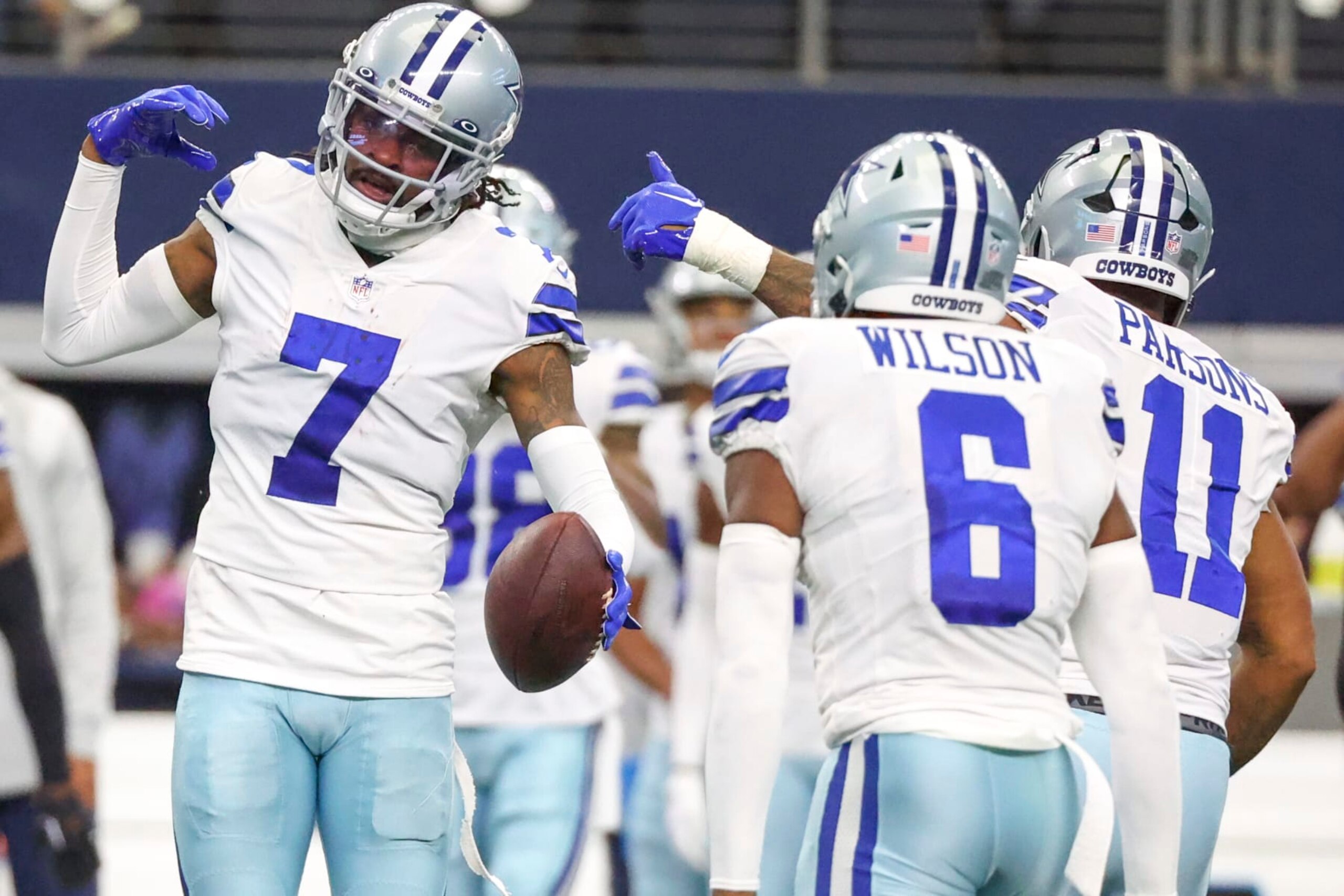 ARLINGTON, TEXAS - OCTOBER 23: Trevon Diggs #7 of the Dallas Cowboys is congratulated by Donovan Wilson #6 and Micah Parsons #11 after making an interception against the Detroit Lions during the third quarter at AT&T Stadium on October 23, 2022 in Arlington, Texas. (Photo by Richard Rodriguez/Getty Images)