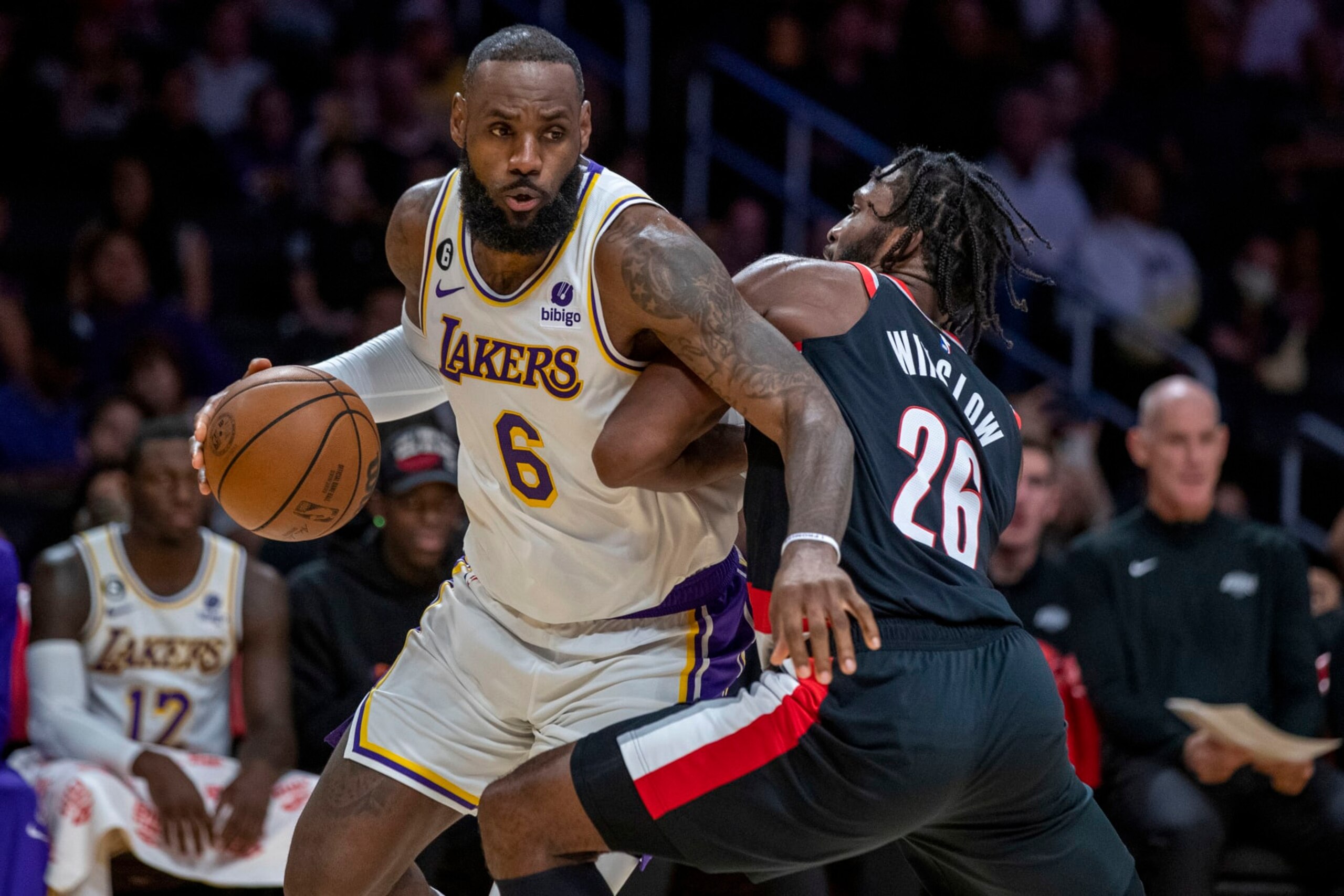 Los Angeles Lakers forward LeBron James, left, drives around Portland Trail Blazers forward Justise Winslow during the first half of an NBA basketball game Sunday, Oct. 23, 2022, in Los Angeles. (AP Photo/Alex Gallardo)