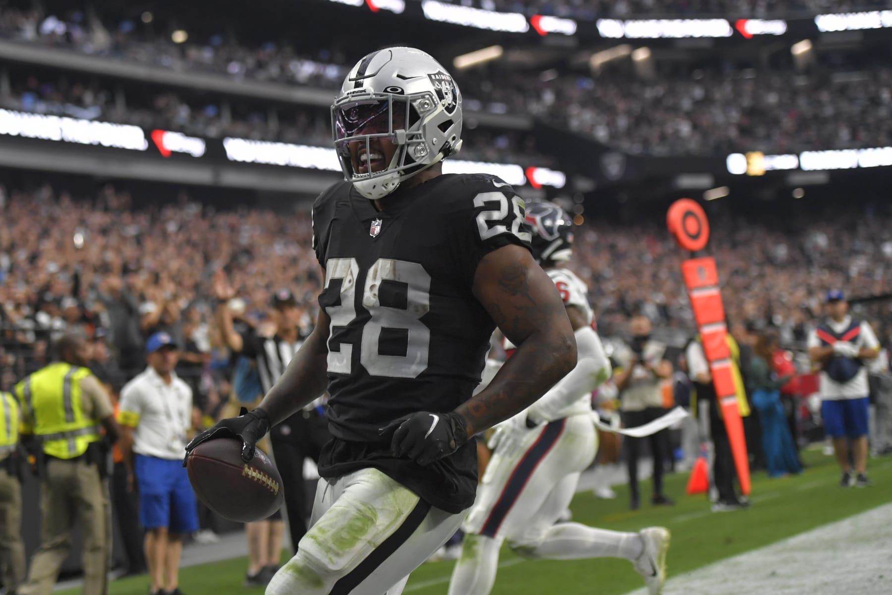 Las Vegas Raiders running back Josh Jacobs, left, scores a touchdown as Houston Texans safety Jonathan Owens defends during the second half of an NFL football game Sunday, Oct. 23, 2022, in Las Vegas. (AP Photo/David Becker) Las Vegas Raiders running back Josh Jacobs, left, scores a touchdown as Houston Texans safety Jonathan Owens defends during the second half of an NFL football game Sunday, Oct. 23, 2022, in Las Vegas. (AP Photo/David Becker)