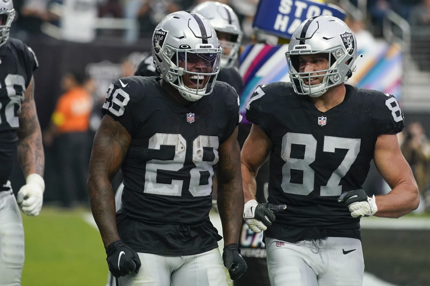 Las Vegas Raiders running back Josh Jacobs (28) reacts with teammates after scoring a touchdown during the second half of an NFL football game against the Houston Texans, Sunday, Oct. 23, 2022, in Las Vegas. (AP Photo/John Locher) Las Vegas Raiders running back Josh Jacobs (28) reacts with teammates after scoring a touchdown during the second half of an NFL football game against the Houston Texans, Sunday, Oct. 23, 2022, in Las Vegas. (AP Photo/John Locher)