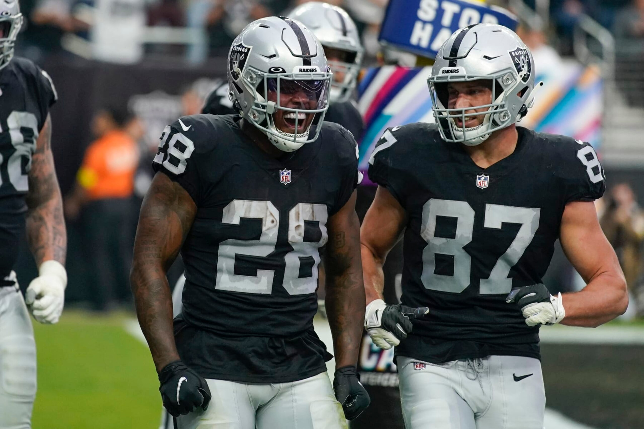 Las Vegas Raiders running back Josh Jacobs (28) reacts with teammates after scoring a touchdown during the second half of an NFL football game against the Houston Texans, Sunday, Oct. 23, 2022, in Las Vegas. (AP Photo/John Locher)